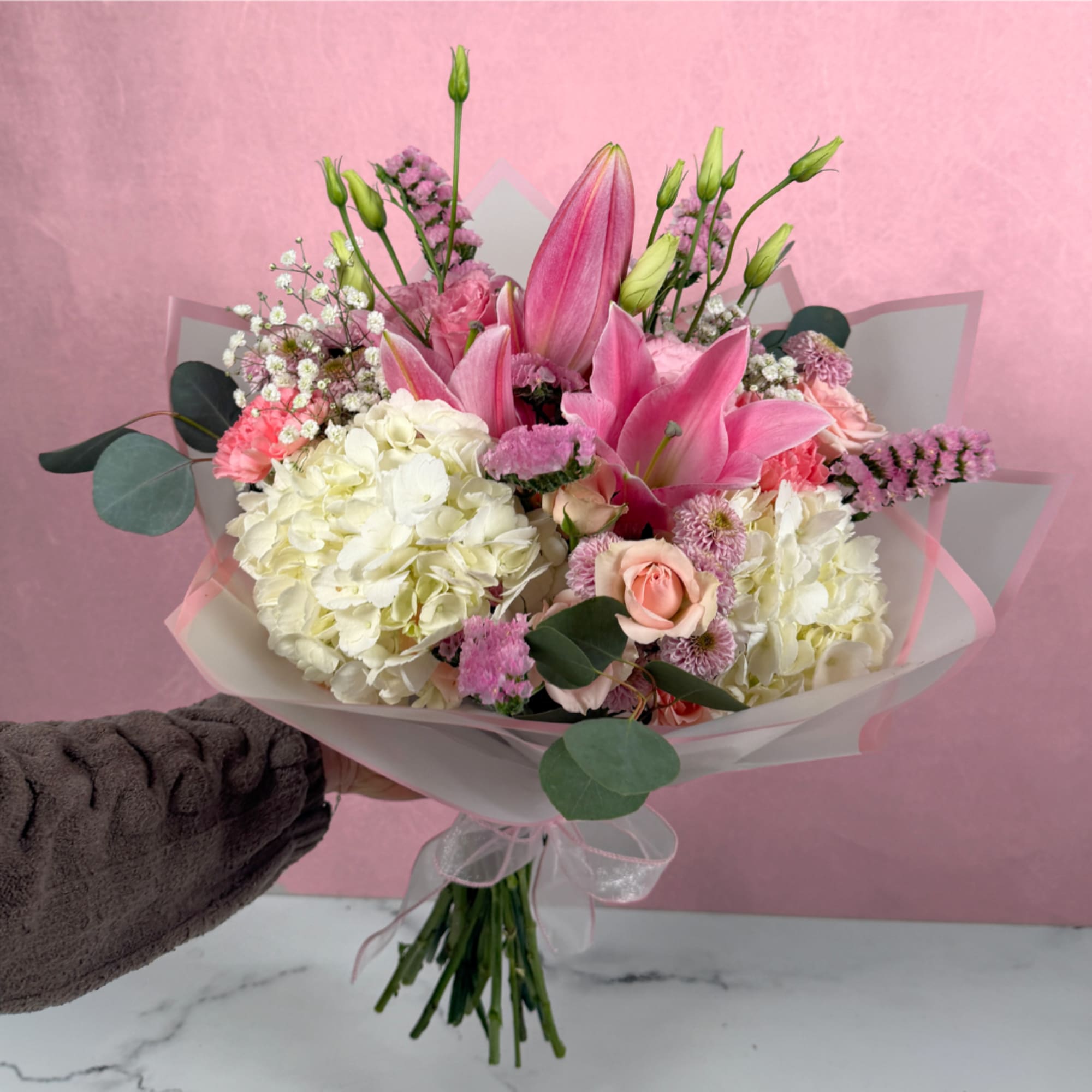Surprise someone special with the Blooms of Beauty Wrapped Bouquet by Savilles