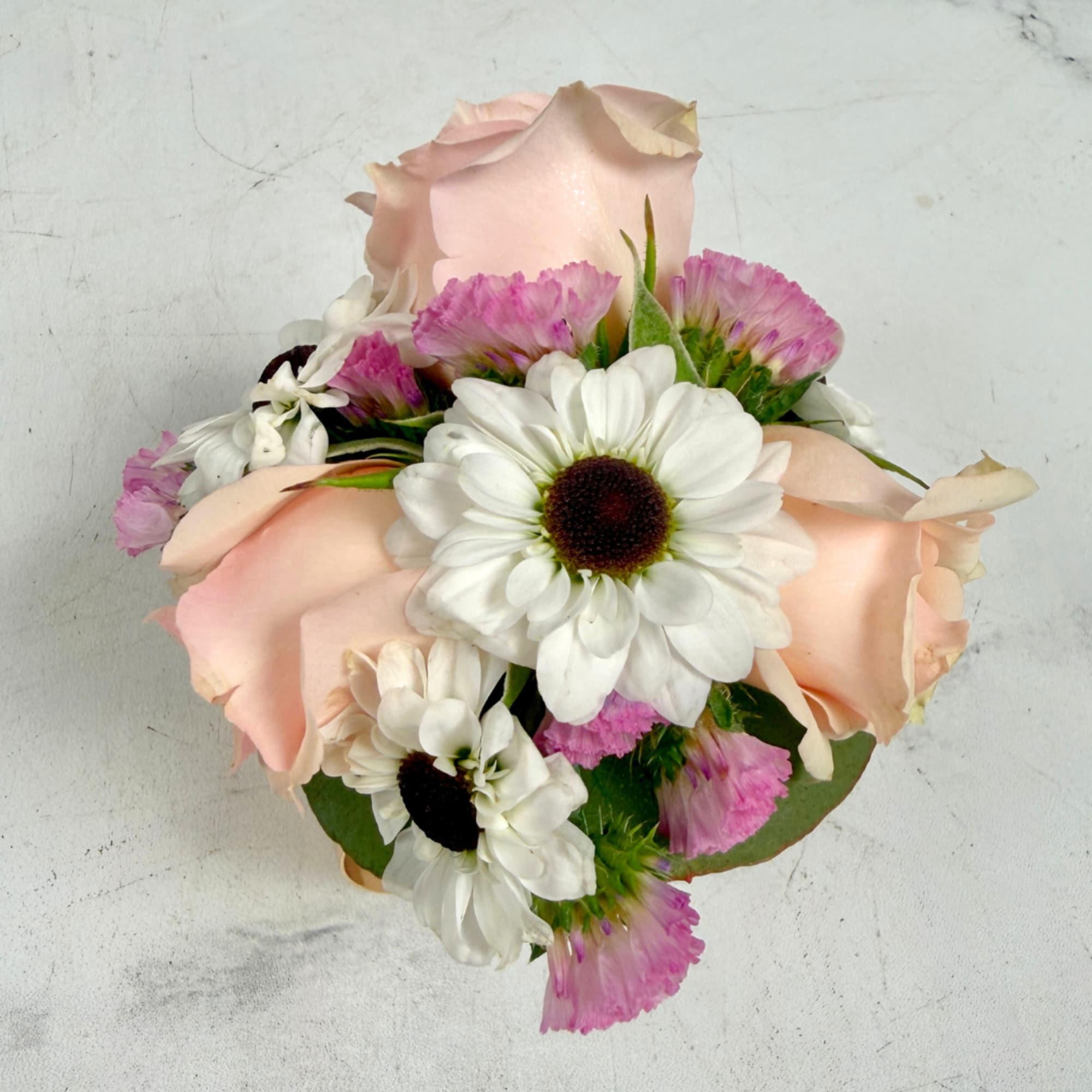 Pale, petite blush spray roses clustered with black and white yin yang, photo 3 of 4