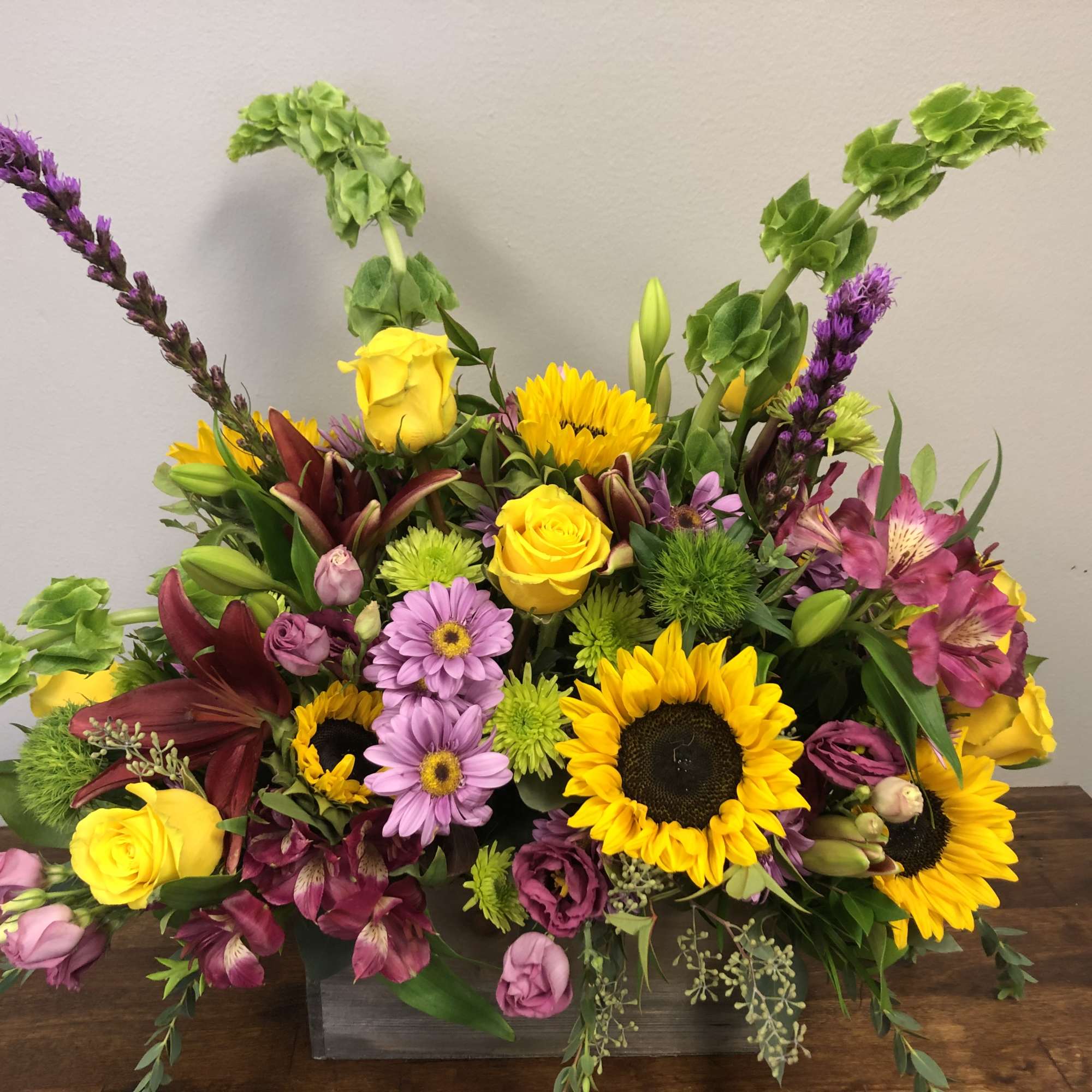  Bright and boldl colors featuring sunflowers in this large floral arrangement., photo 2 of 2