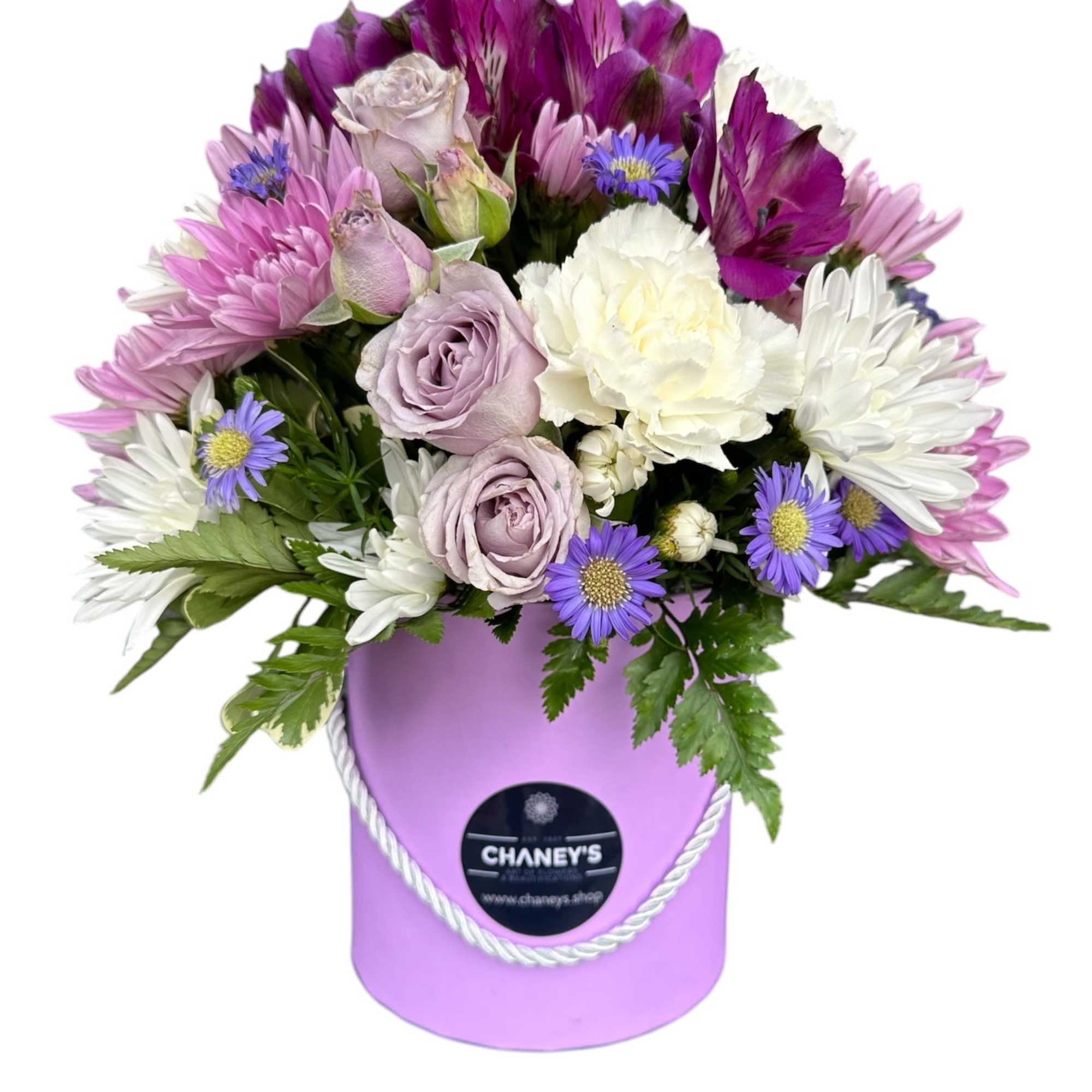 Lavender and white bouquet in a purple hatbox