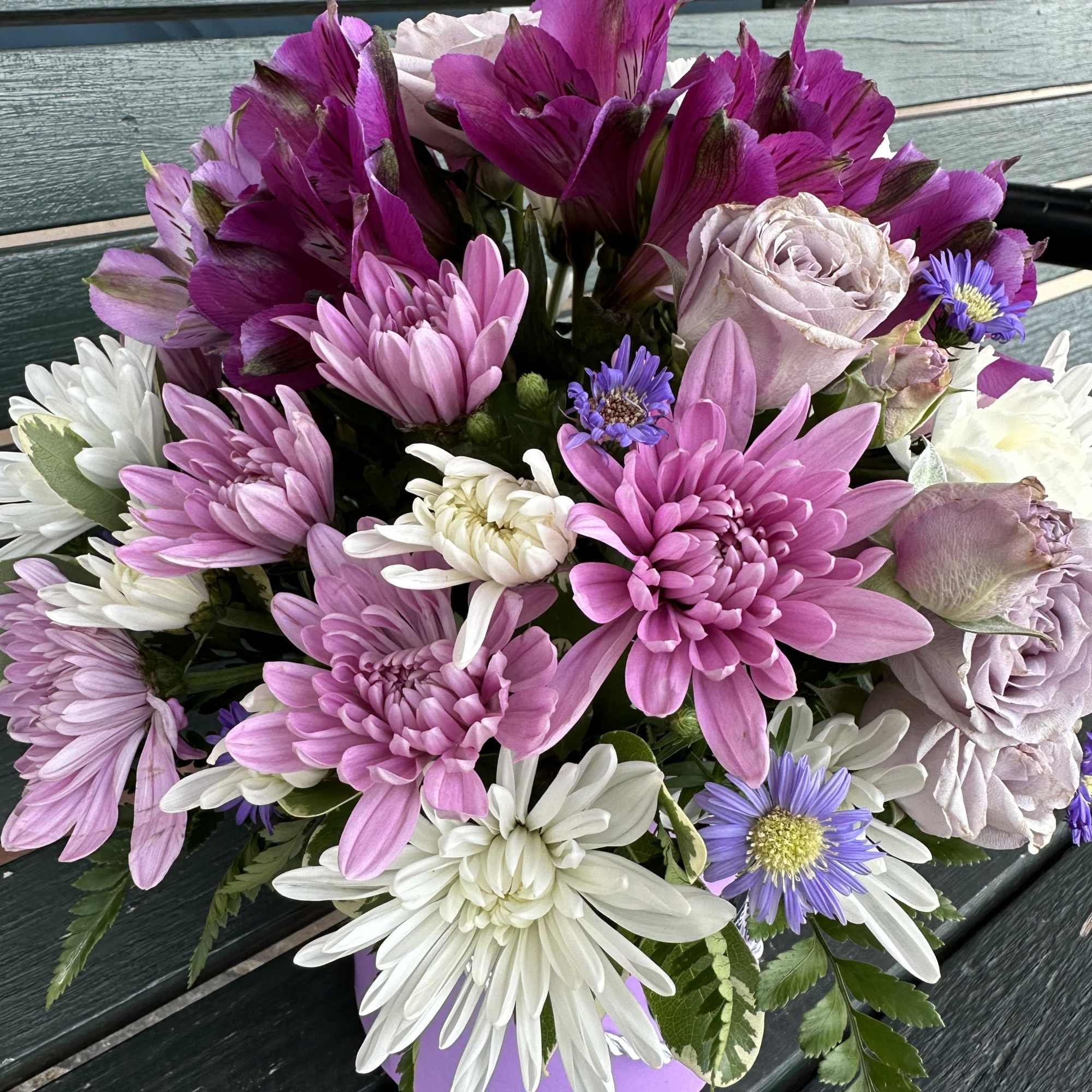 Bouquet of pink, white, and purple flowers in a lavender box