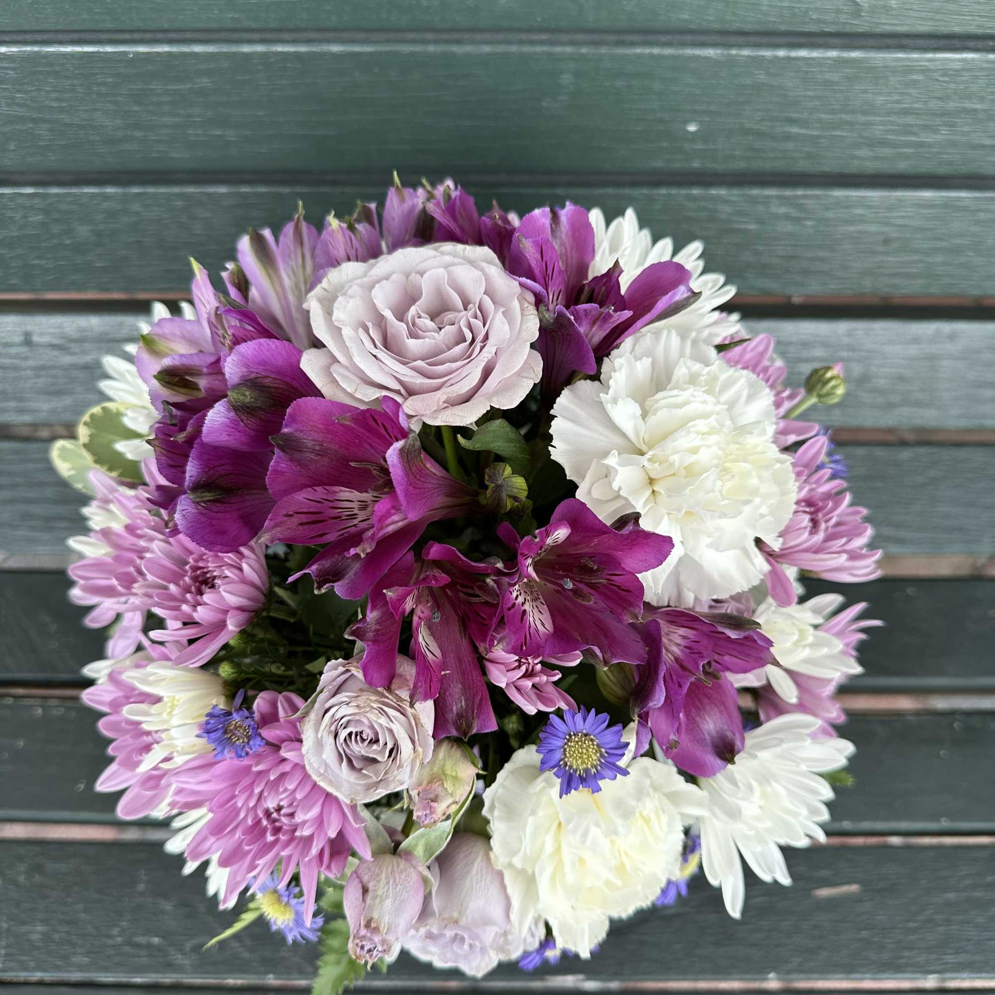 Round bouquet of pink, white, and purple flowers