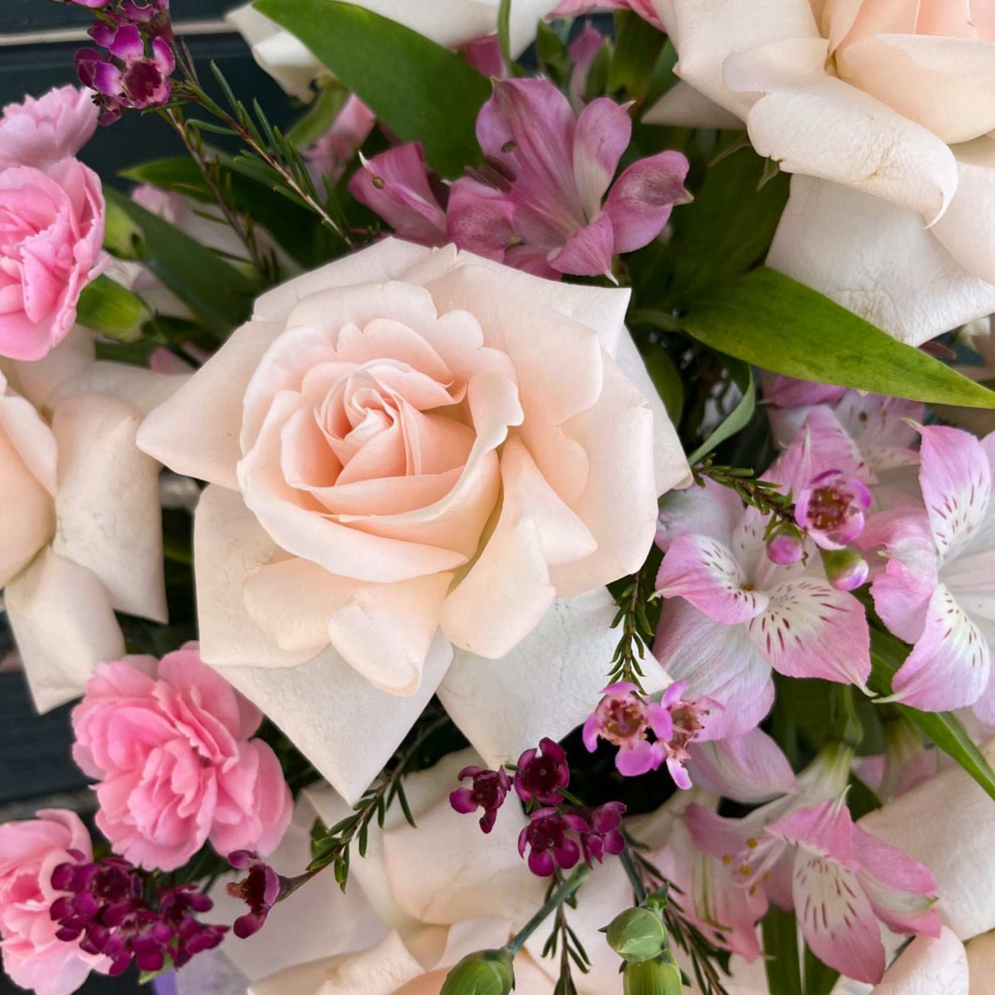Bouquet of pale peach roses and pink flowers