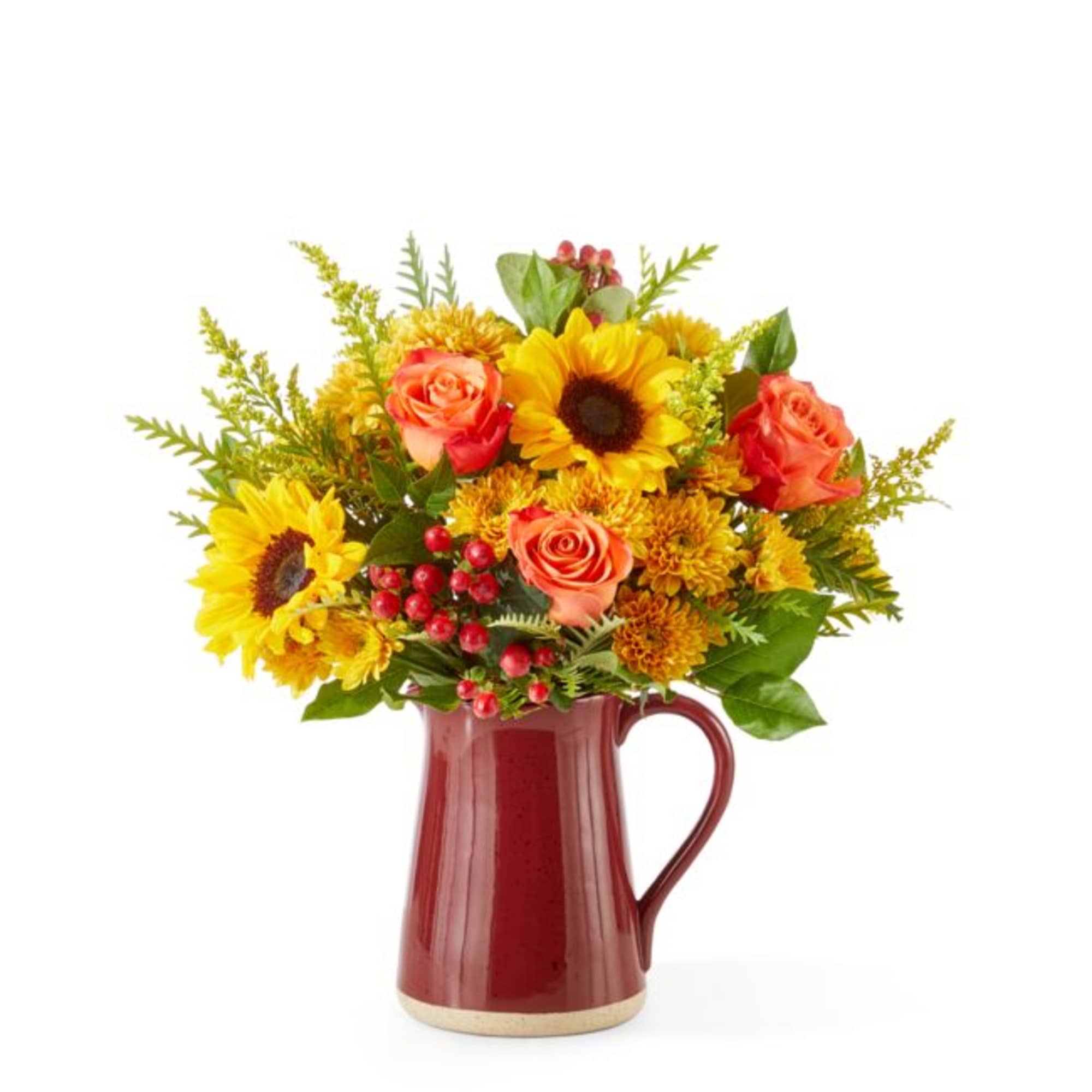 Sunflowers and orange roses arranged in a red pitcher vase