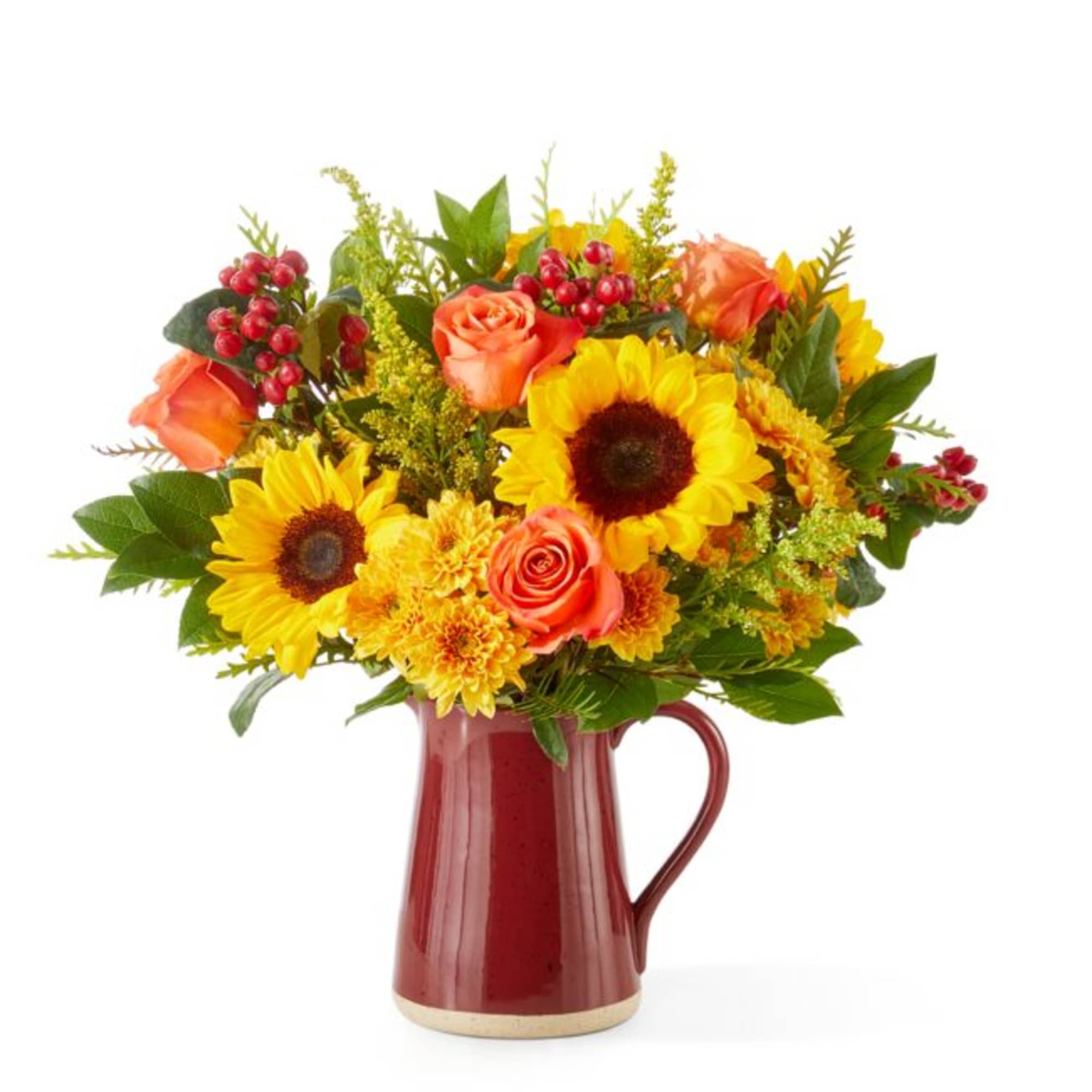 Bouquet of sunflowers, orange roses, and yellow mums in a red pitcher vase