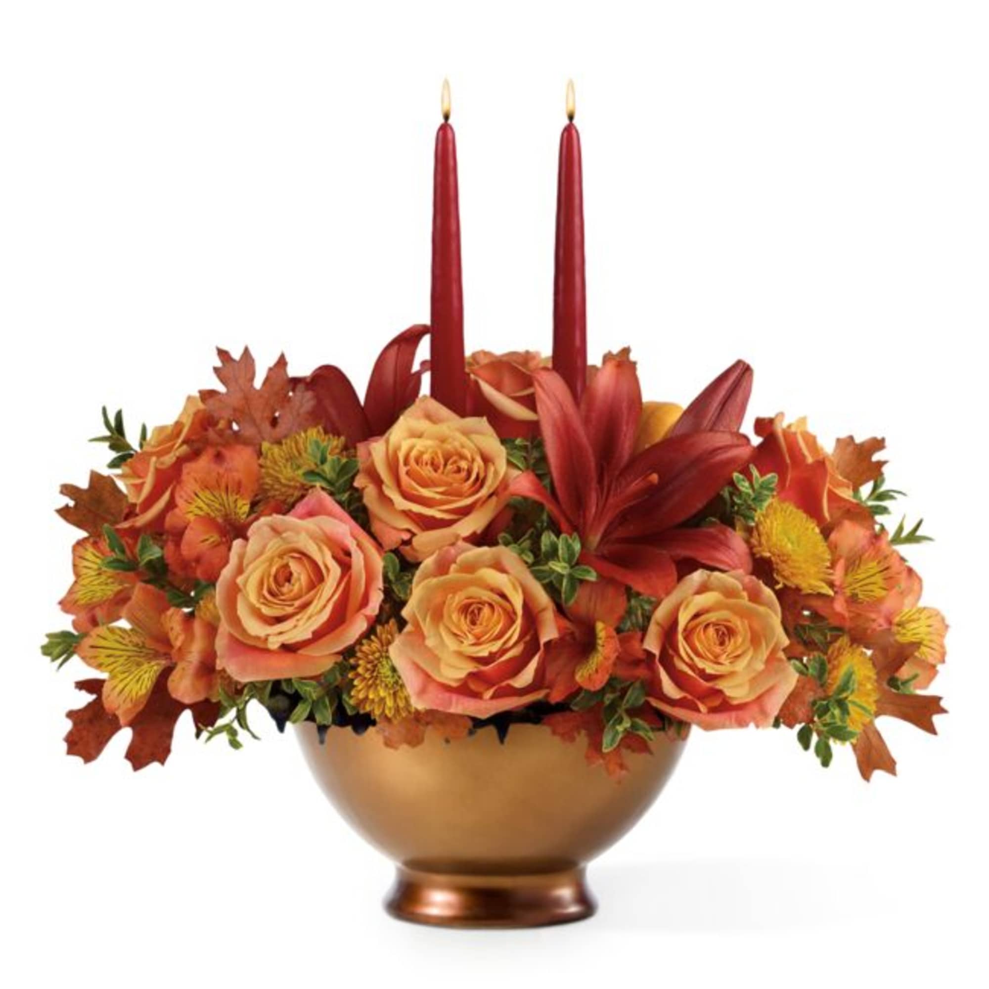 Autumn floral arrangement with red candles in a gold bowl