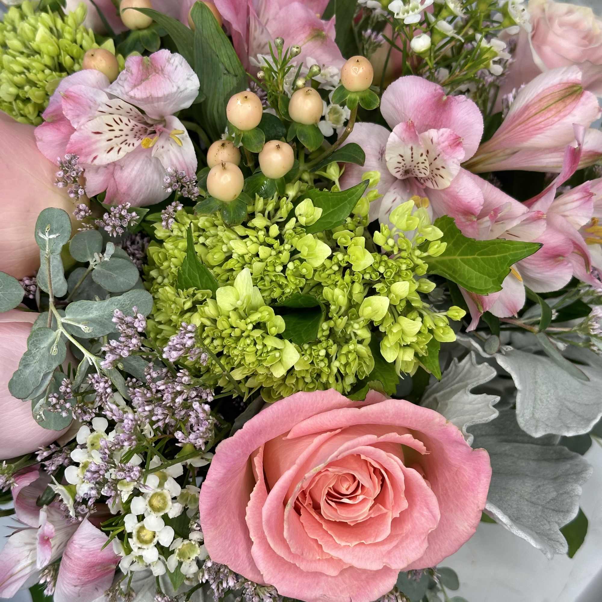 Pink roses and alstroemeria with green hydrangea in a bouquet