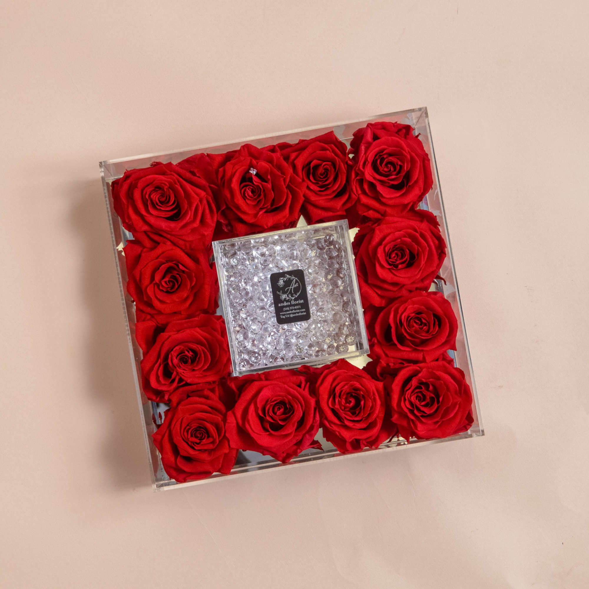 Square box of red roses with a clear jeweled center