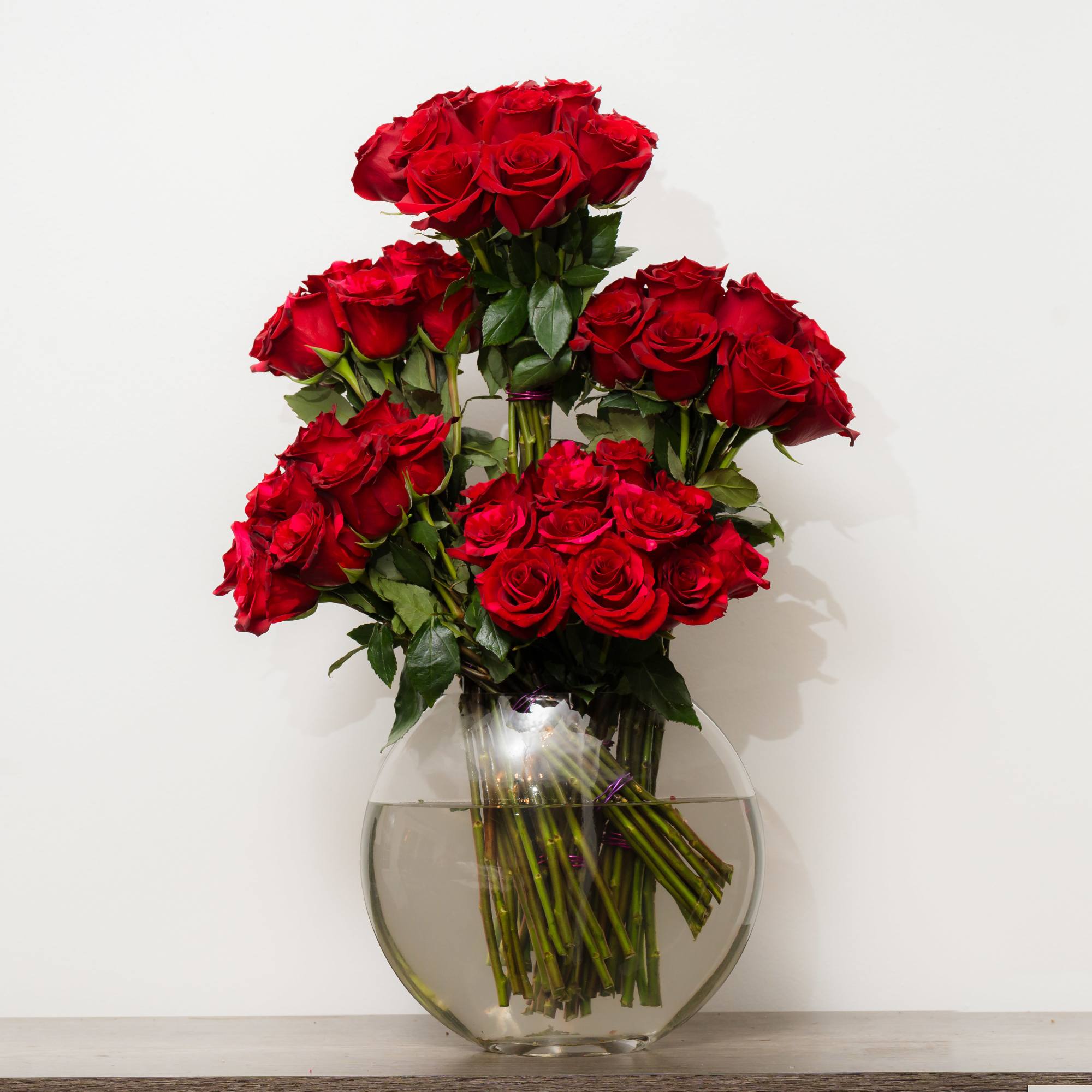 Bouquet of red roses in a clear glass vase