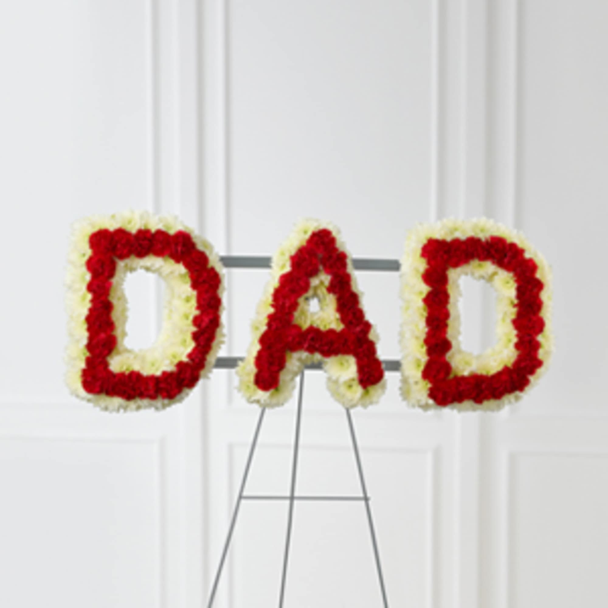 Floral tribute spelling DAD in red and white flowers