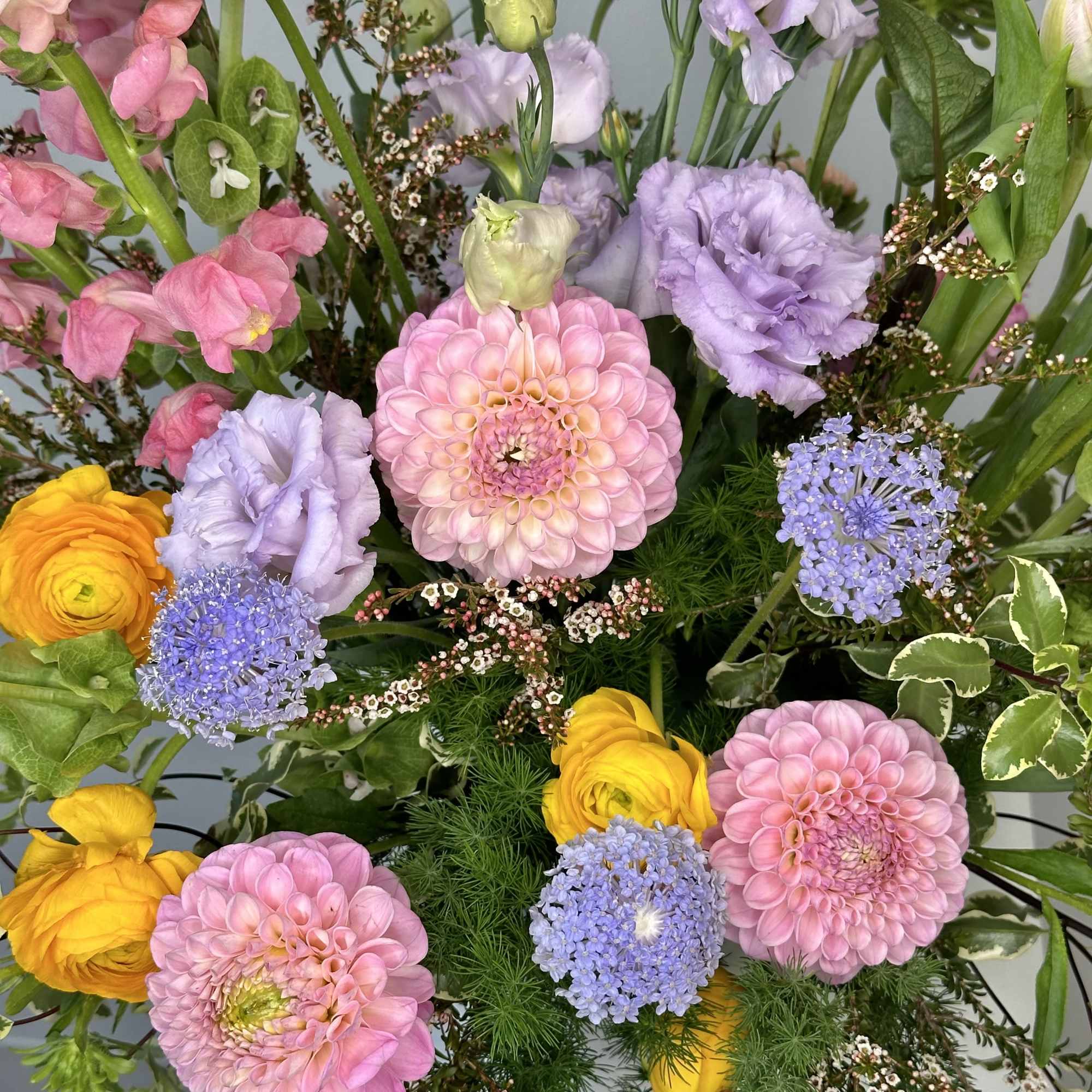 Mixed bouquet with pink and lavender blooms and yellow flowers