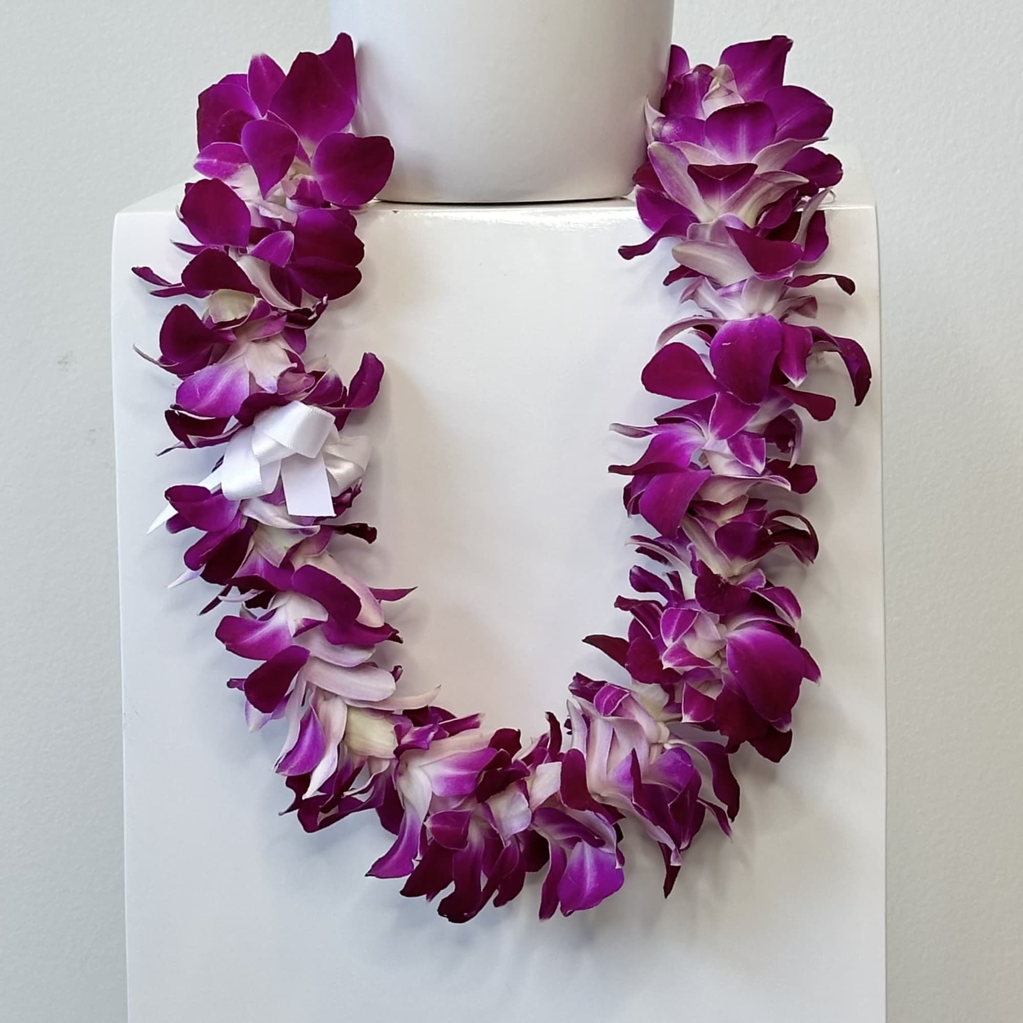 Celebrate a meaningful milestone with a beautifully crafted Orchid Lei, a timeless