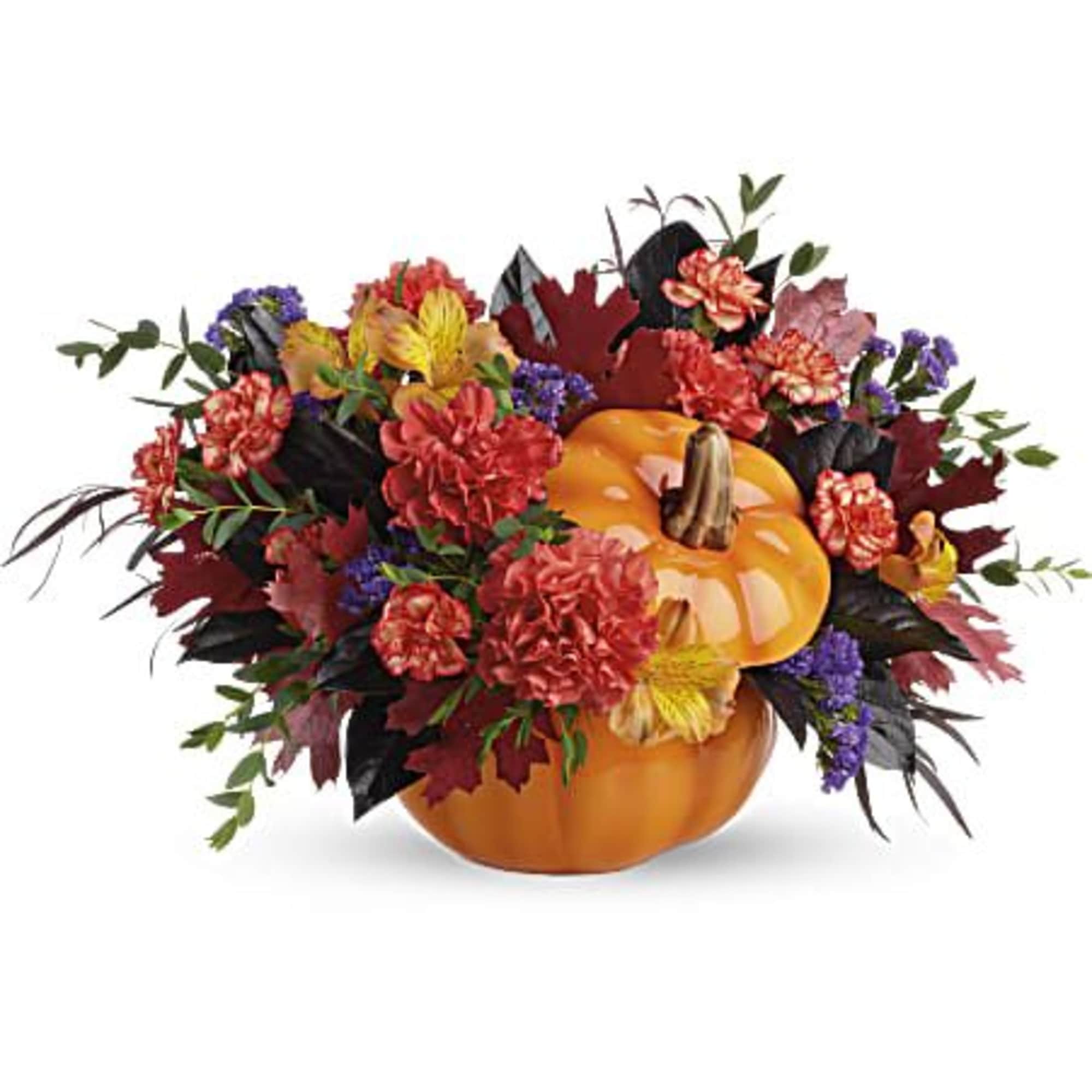 Pumpkin centerpiece with mixed fall flowers and leaves