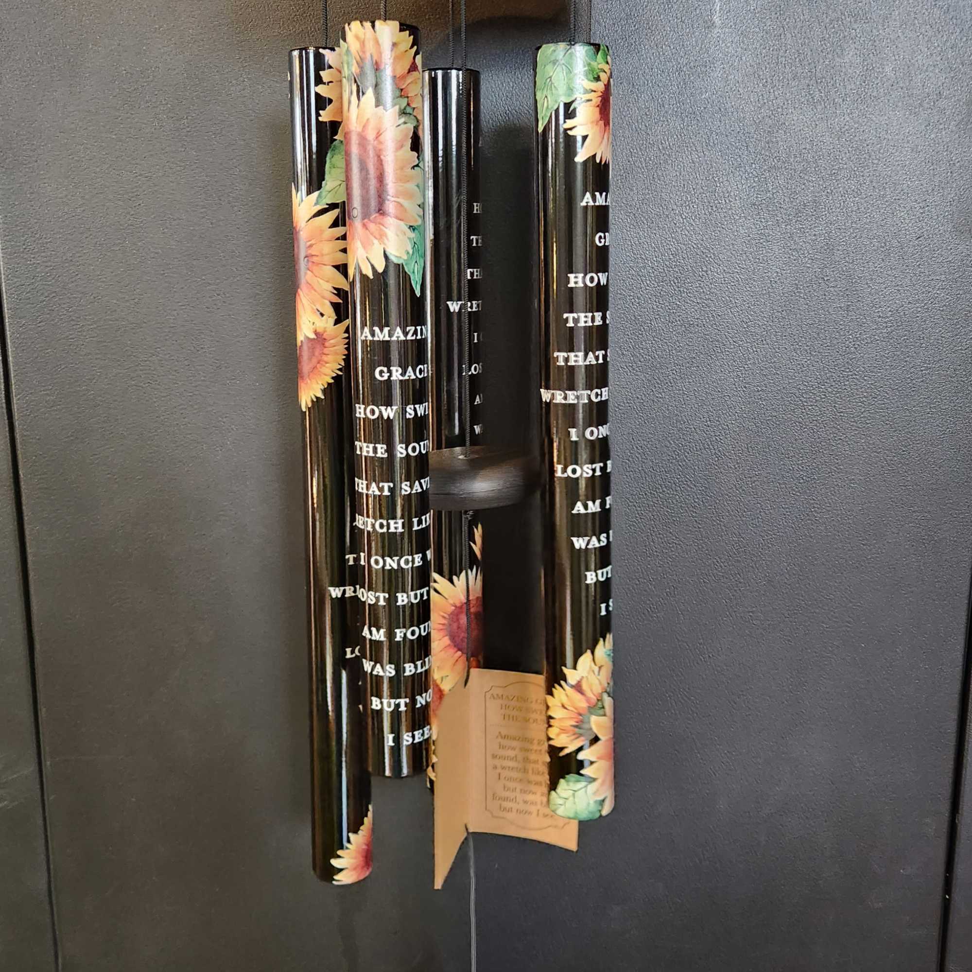 Black memorial wind chime with sunflower tubes and a hanging leaf-shaped pendant