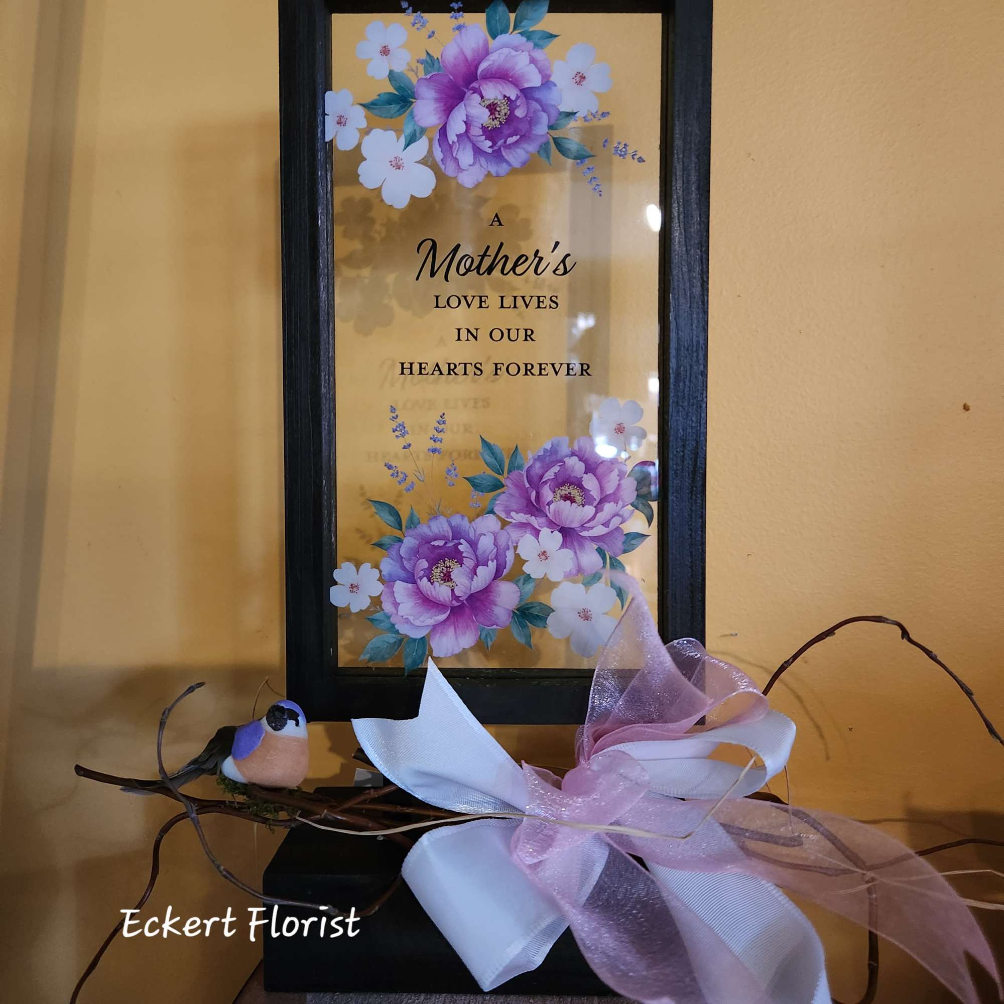 Framed Mother's Day memorial sign with purple flowers and a ribbon bow