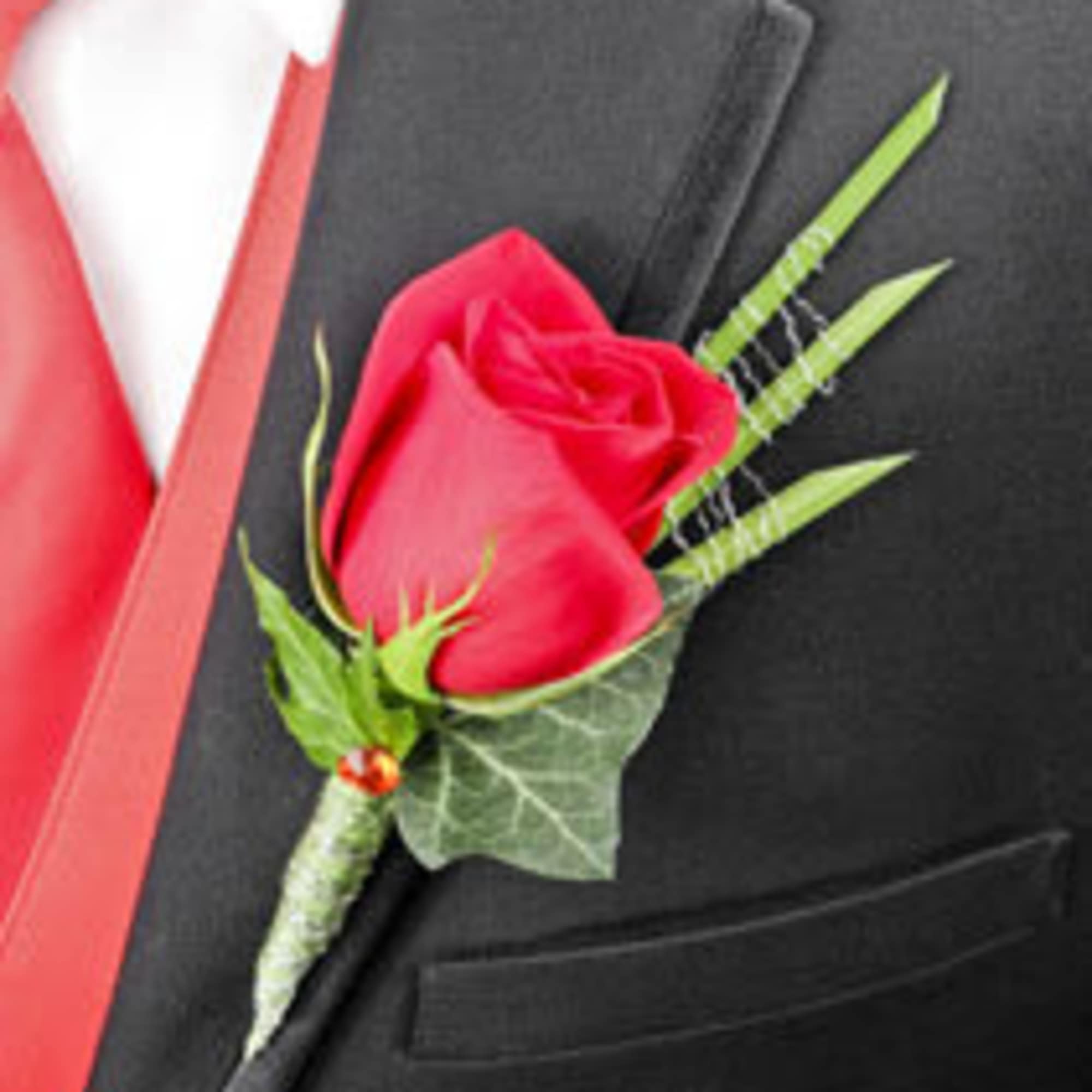 Red rose boutonniere on a black suit jacket