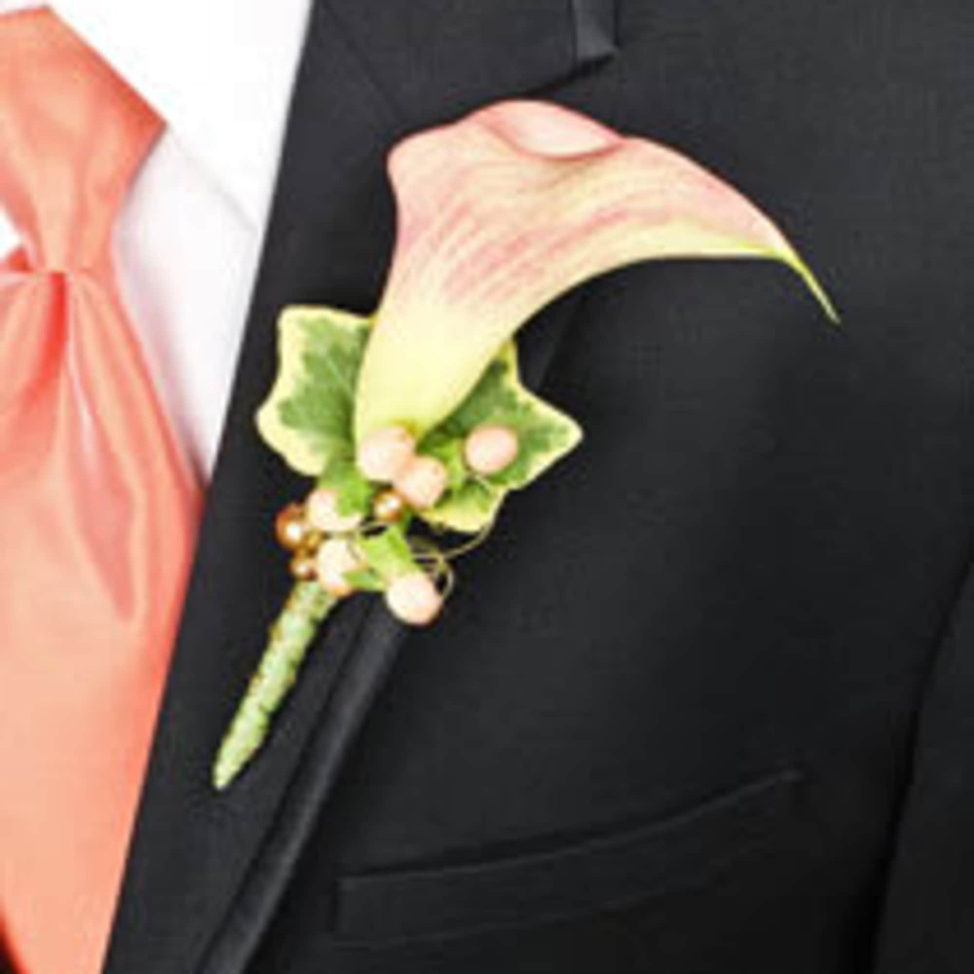 Calla lily boutonniere on a black suit jacket
