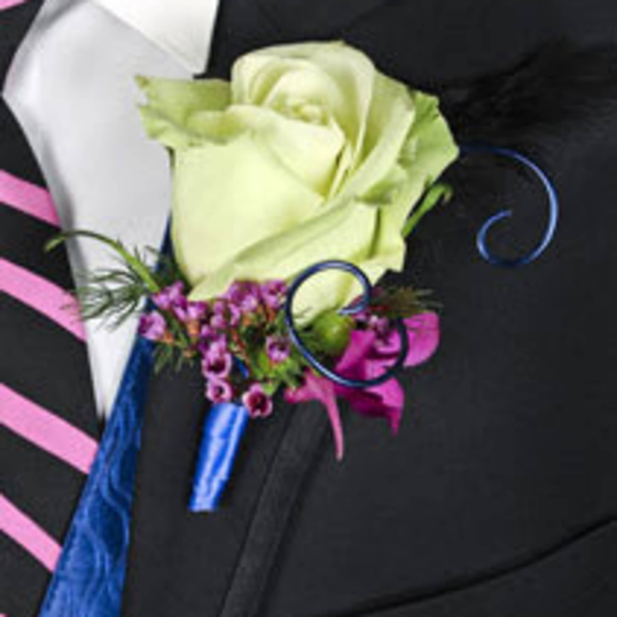 Boutonniere with a pale green rose and purple accent flowers