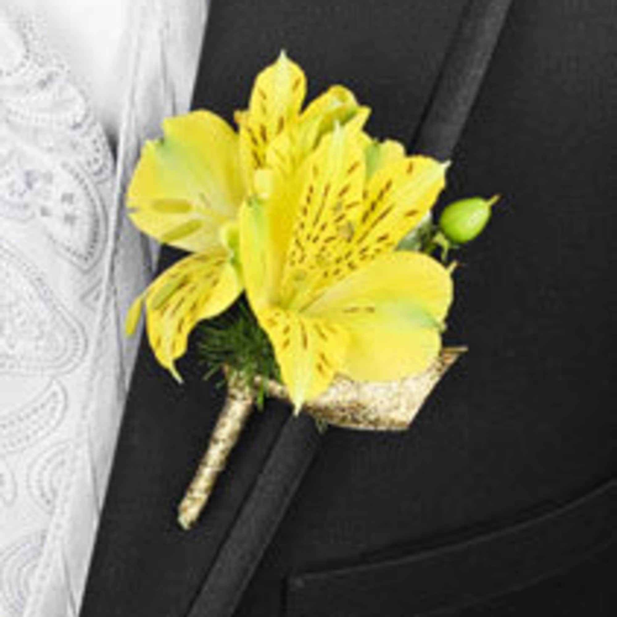 Yellow boutonniere pinned to a black suit jacket