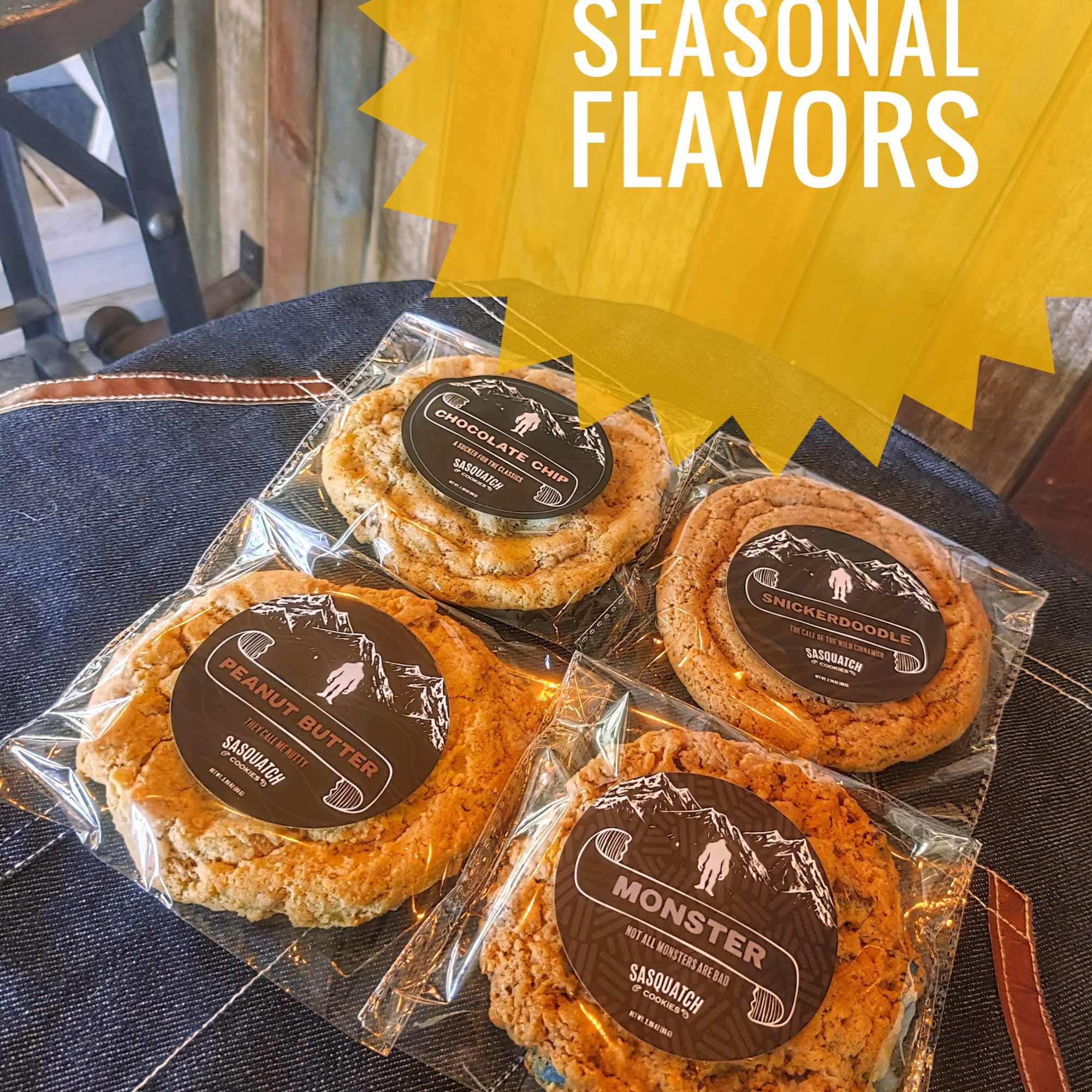 Four packaged cookies on a chair with a yellow sign above