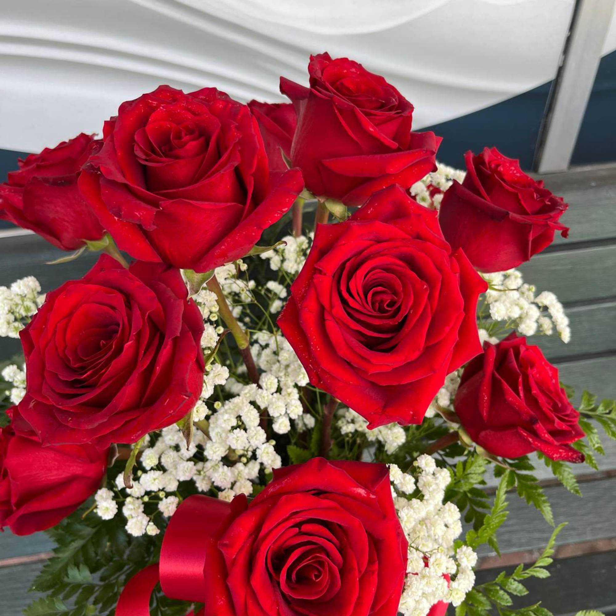 Bouquet of red roses with white baby's breath and a red ribbon
