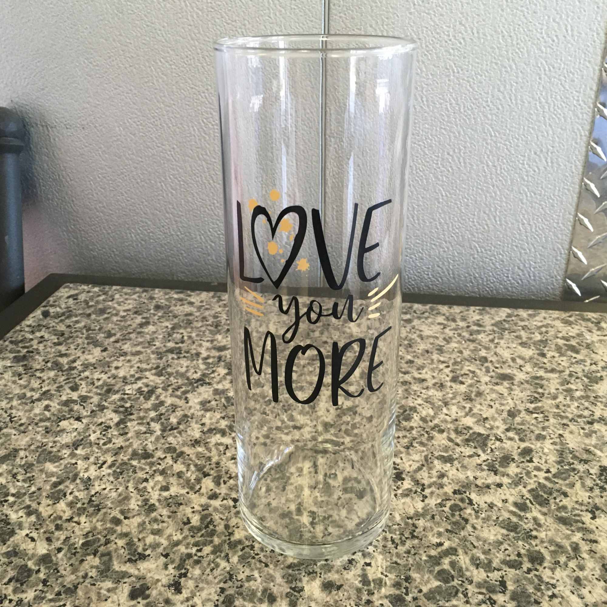 Clear glass vase with "Love you more" text