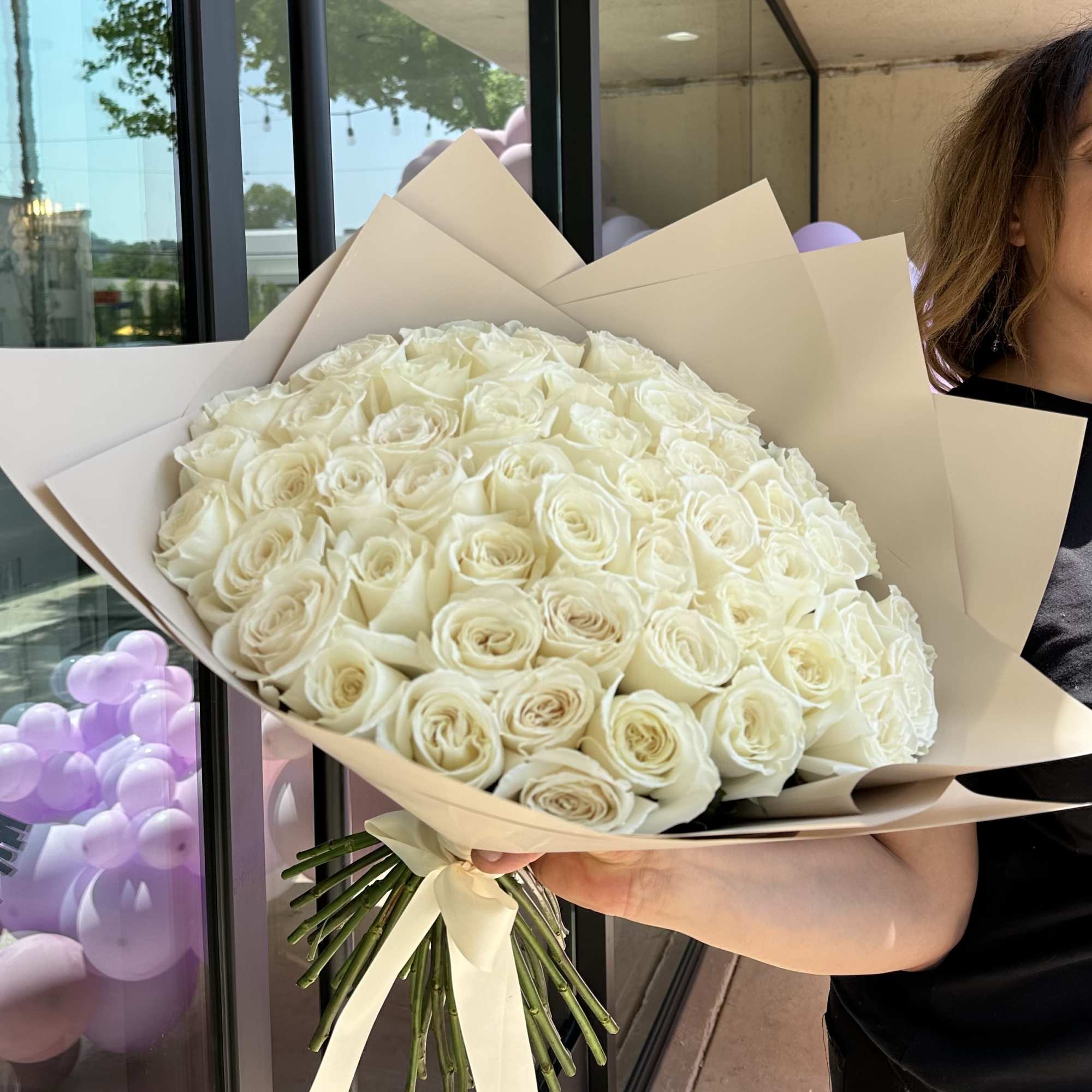 Large bouquet of white roses wrapped in beige paper, photo 3 of 3