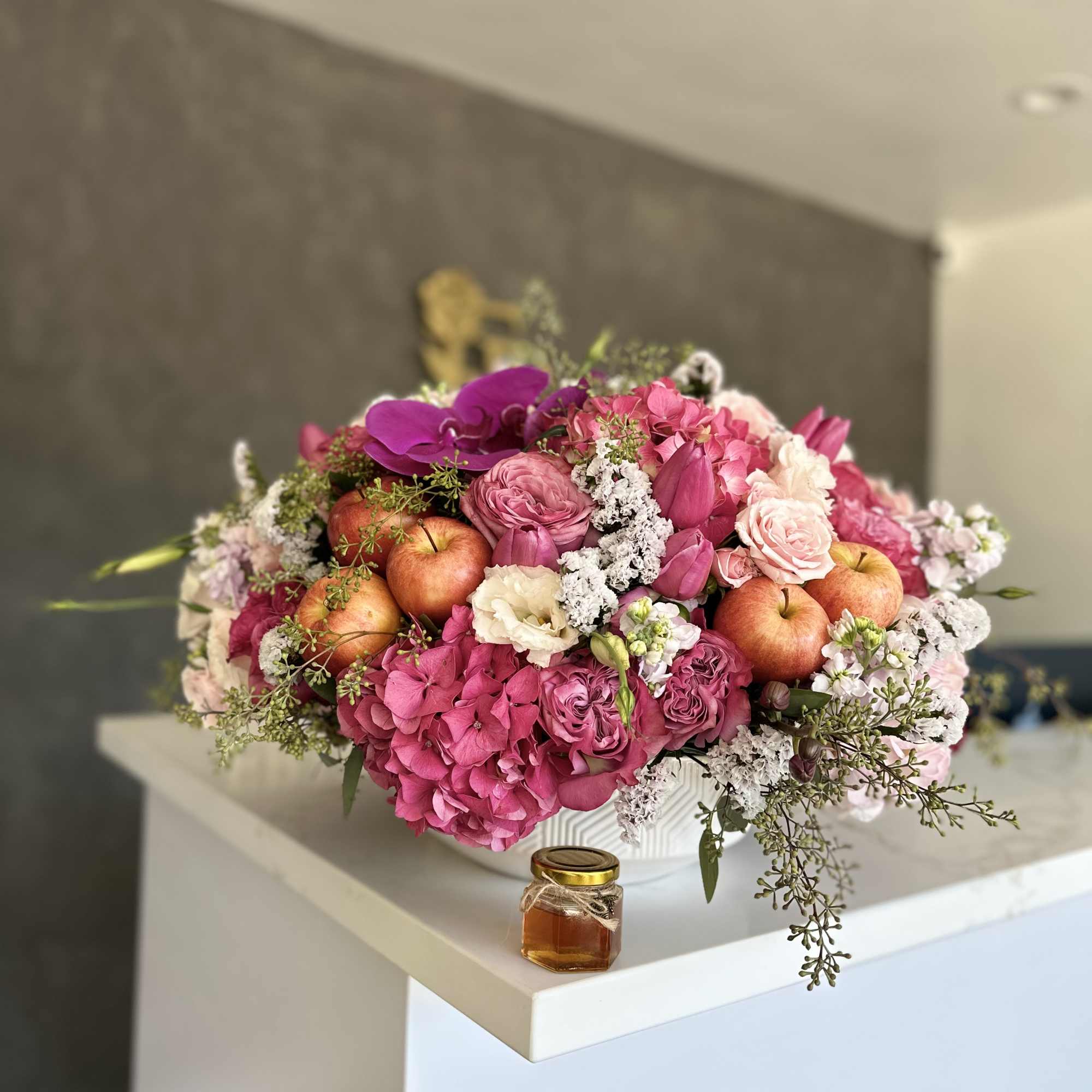 Pink floral arrangement with apples in a white vase, photo 3 of 3
