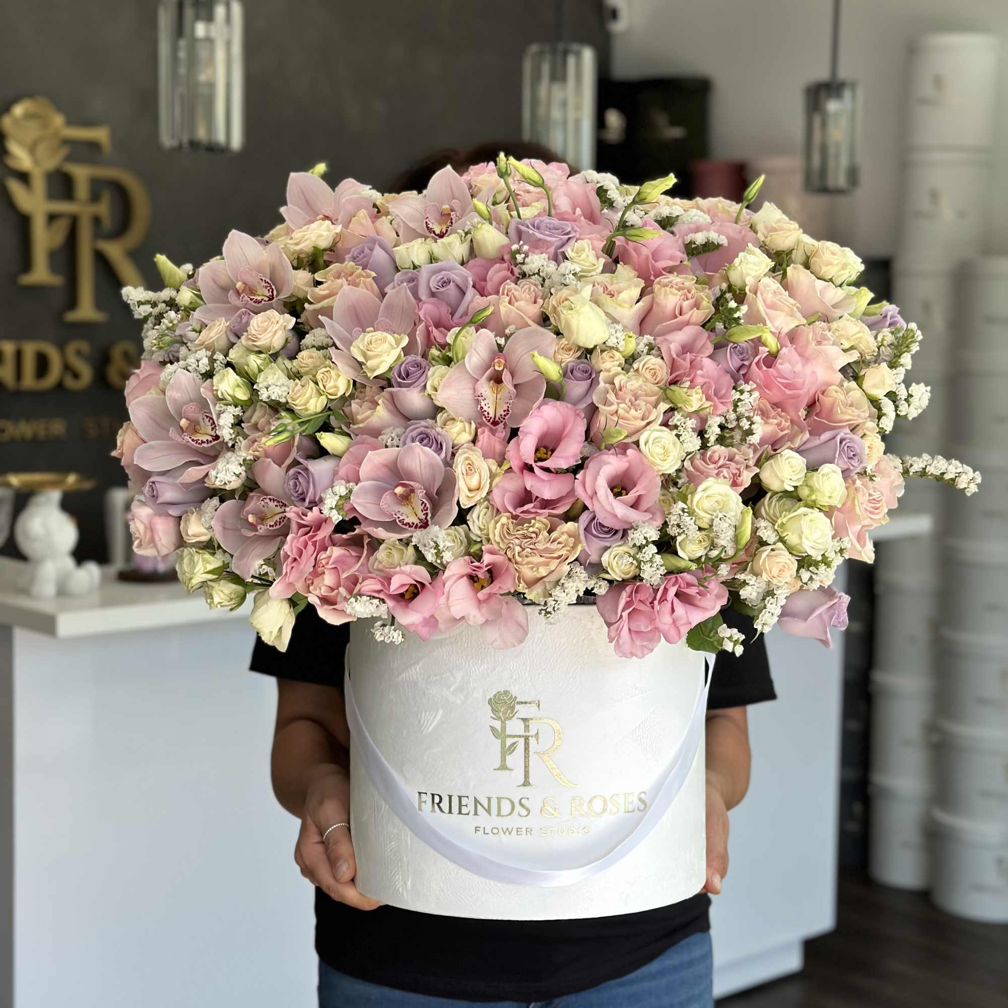 Large pastel bouquet in a white hatbox with pink and lavender flowers