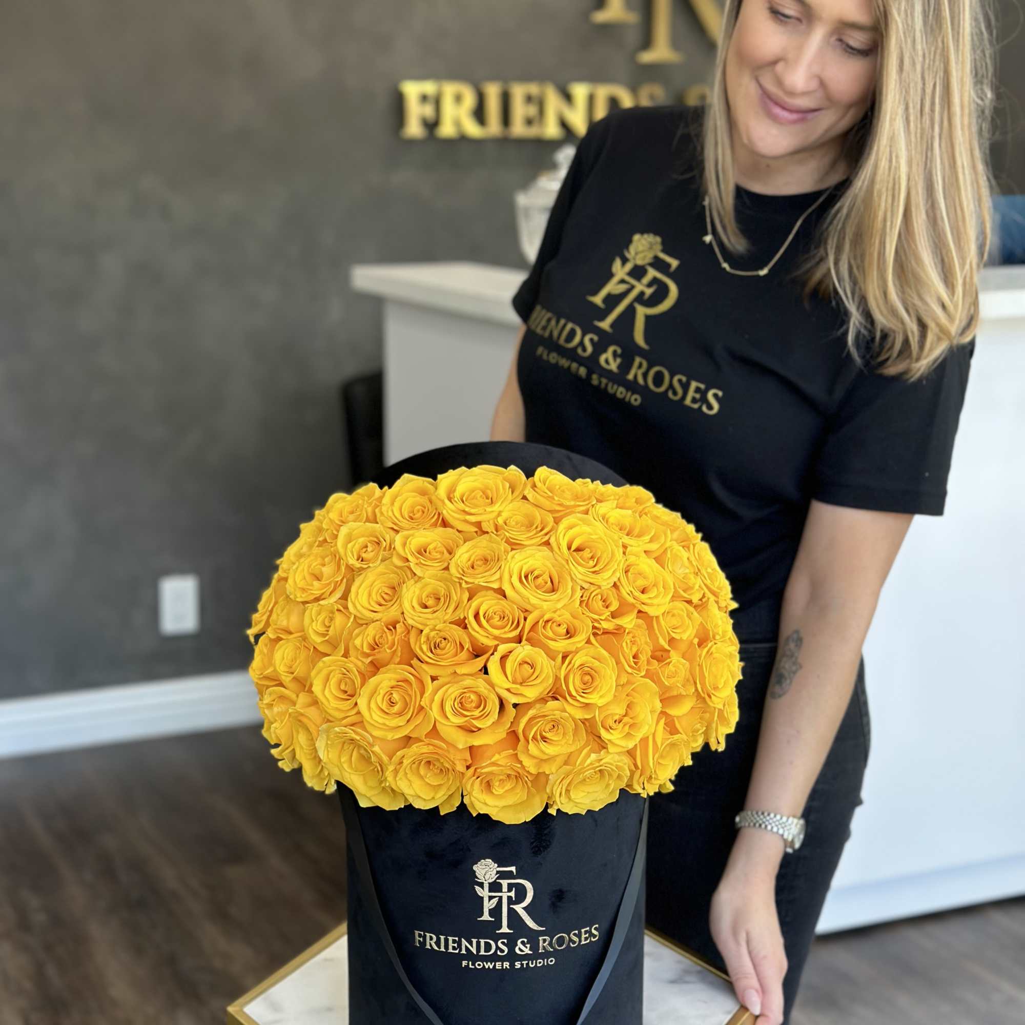 Large yellow rose arrangement in a black hat box
