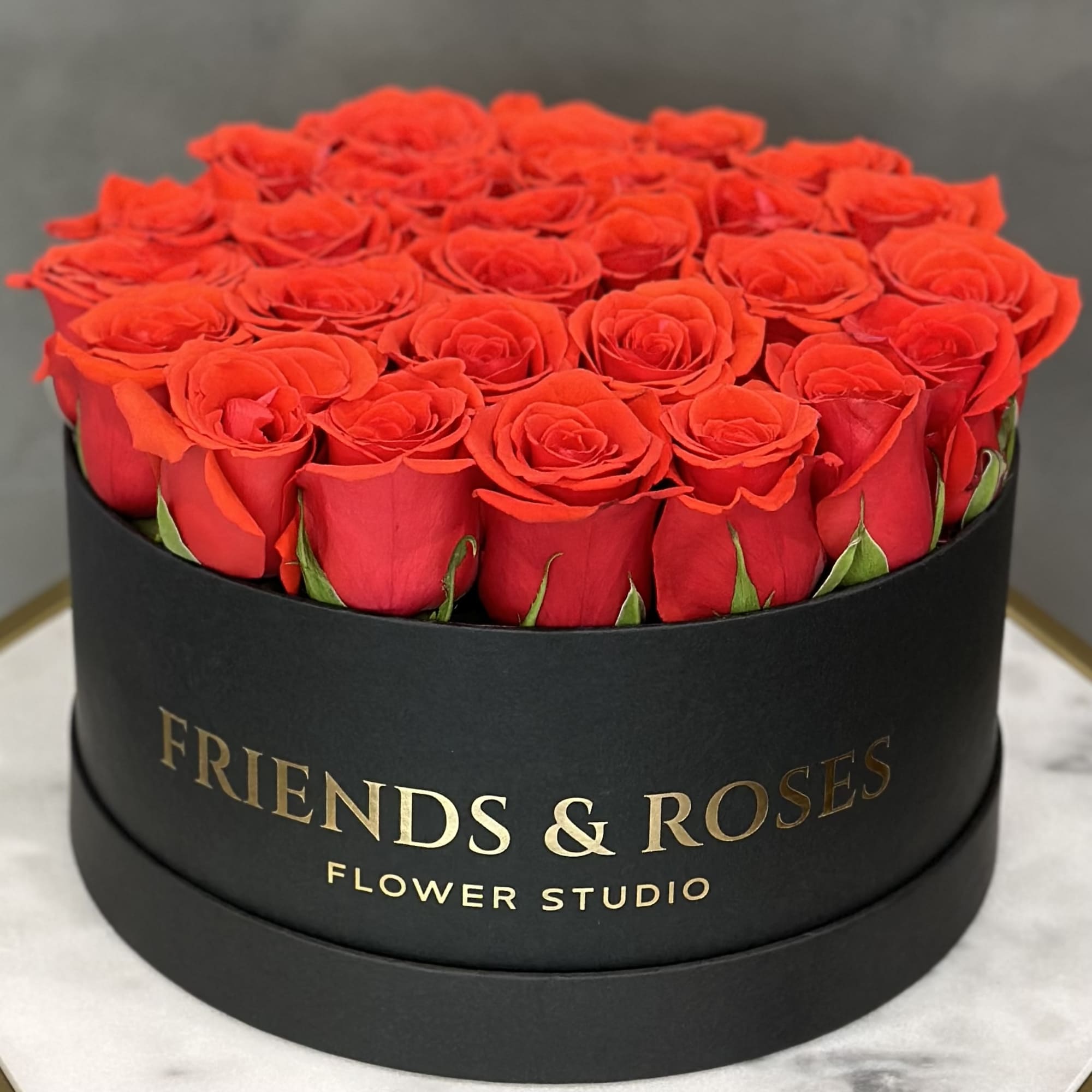 Round box filled with red roses