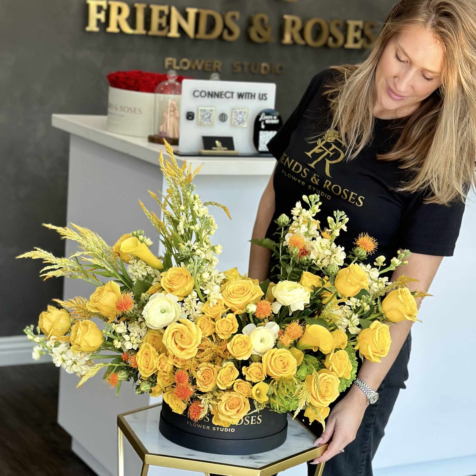 Large yellow rose arrangement in a black hat box