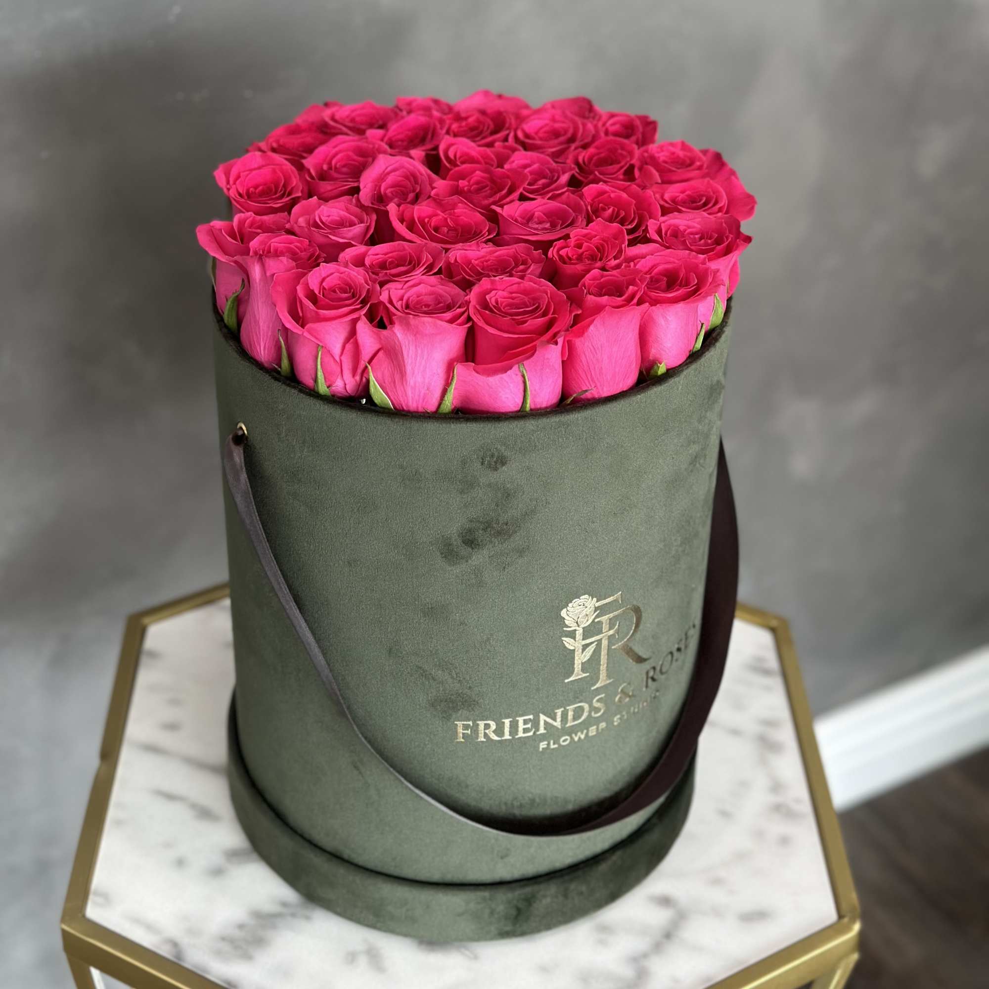 Hot pink roses arranged in a round green hat box, photo 2 of 2