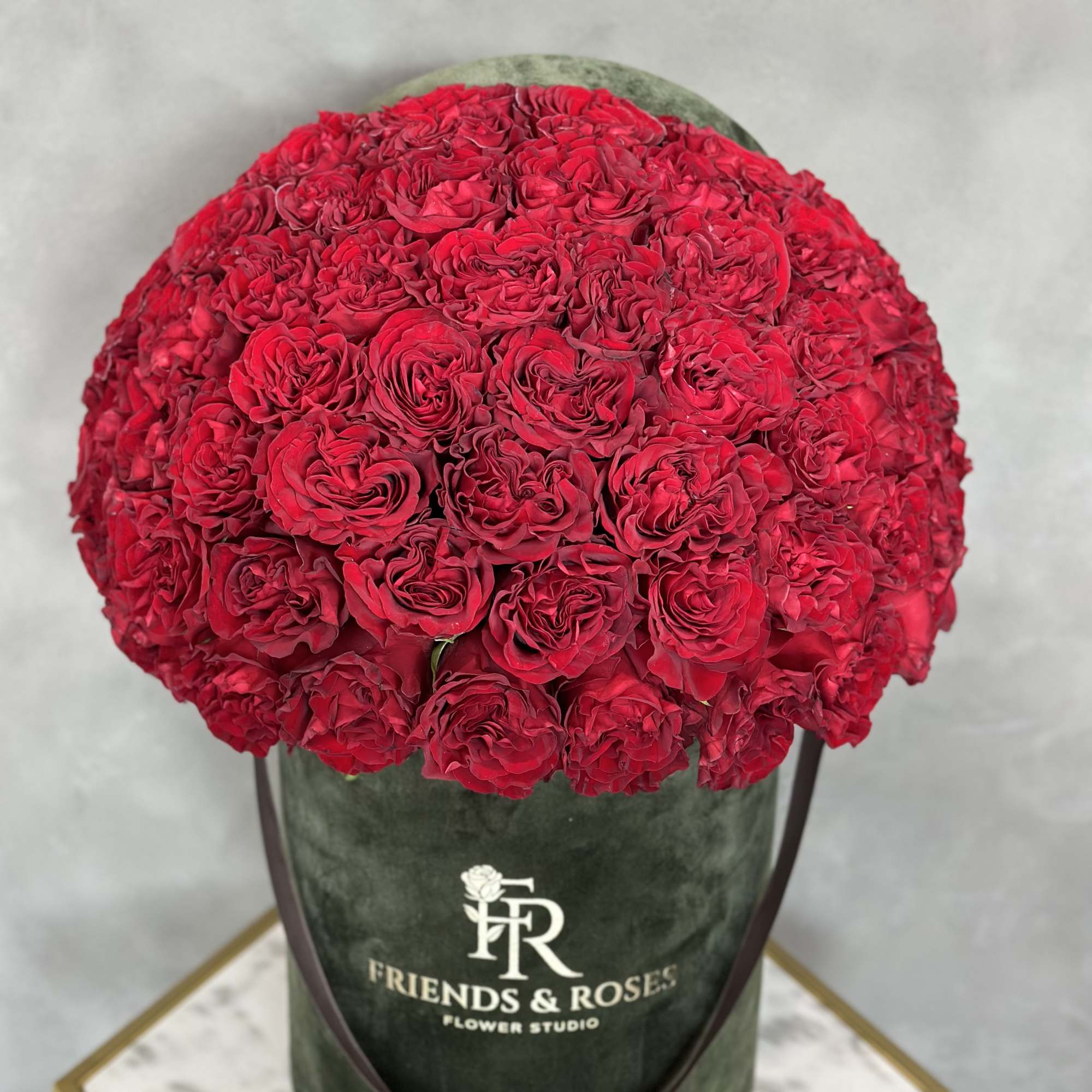 Large dome of red roses in a dark green hatbox, photo 2 of 3