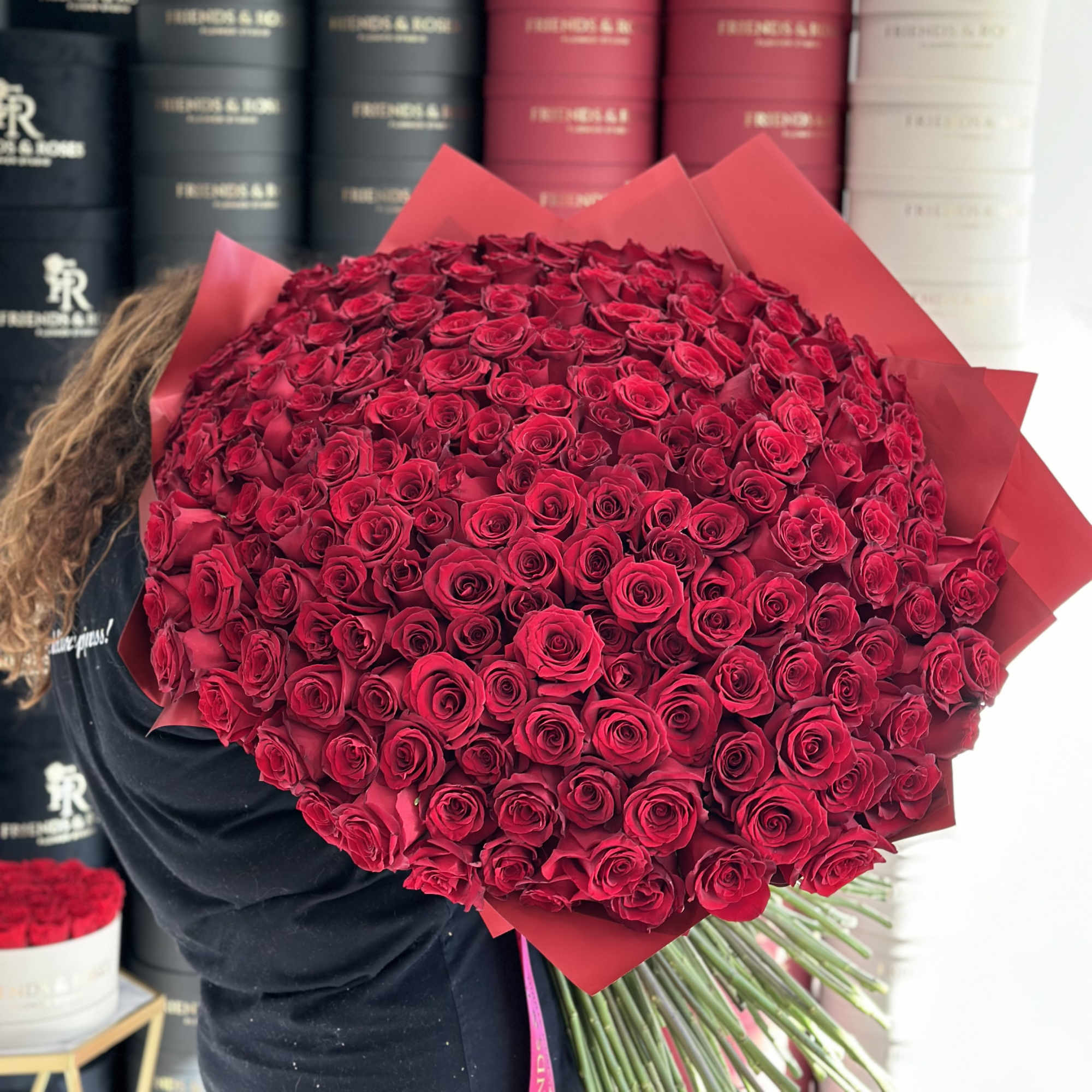 Large bouquet of red roses wrapped in red paper, photo 2 of 3