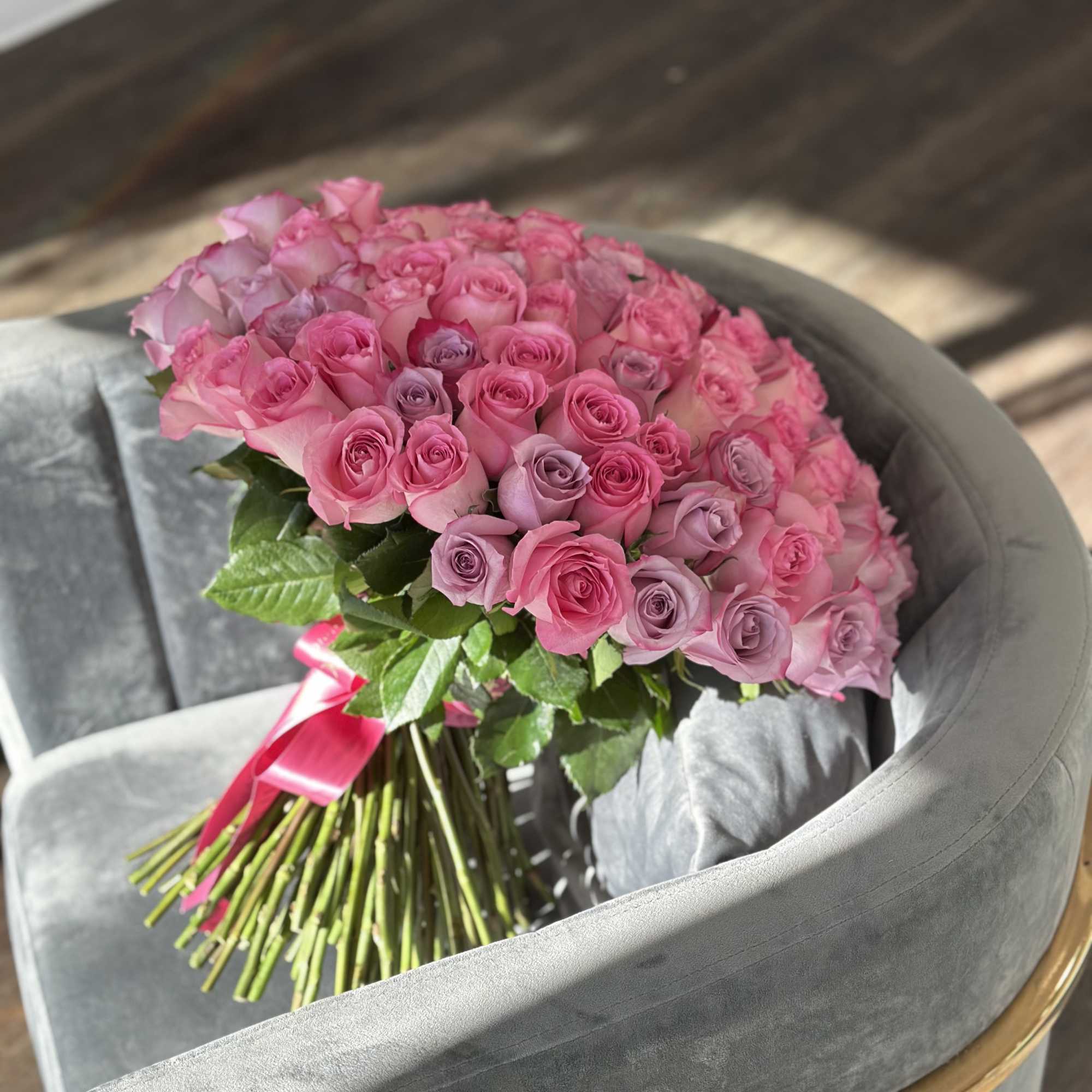 Large bouquet of pink and lavender roses tied with a ribbon