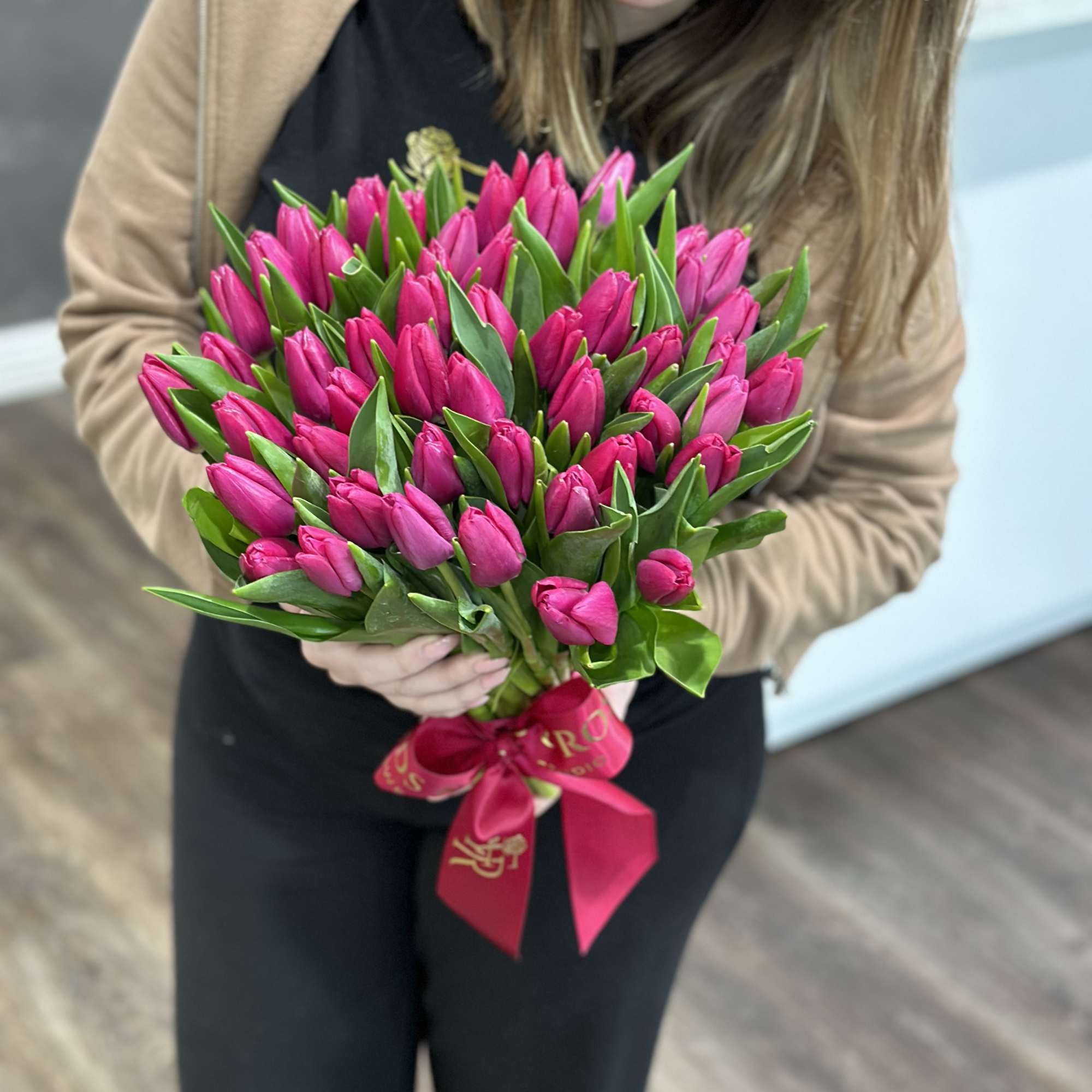 Bouquet of bright pink tulips tied with a pink ribbon