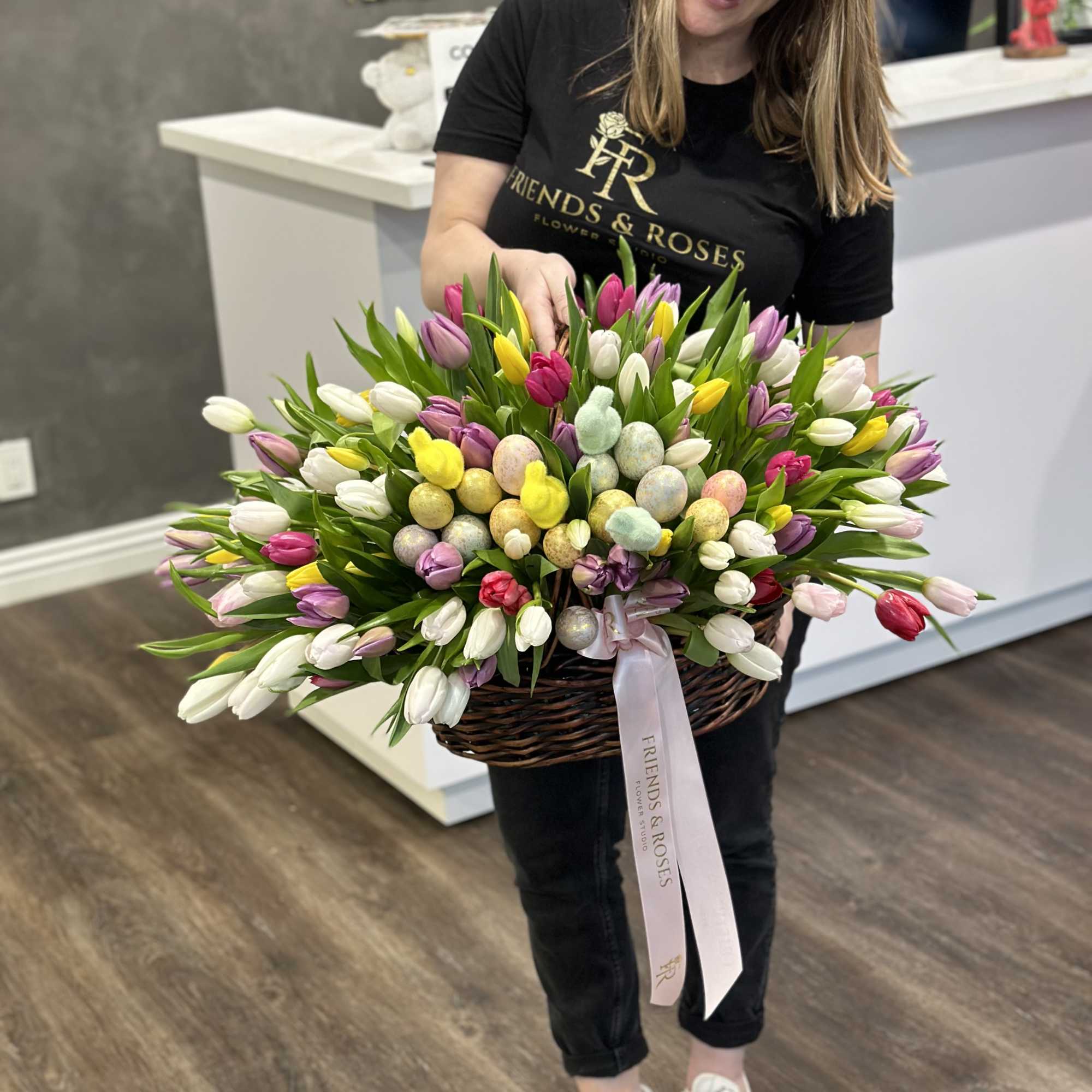 Basket of multicolored tulips with pastel decorative eggs