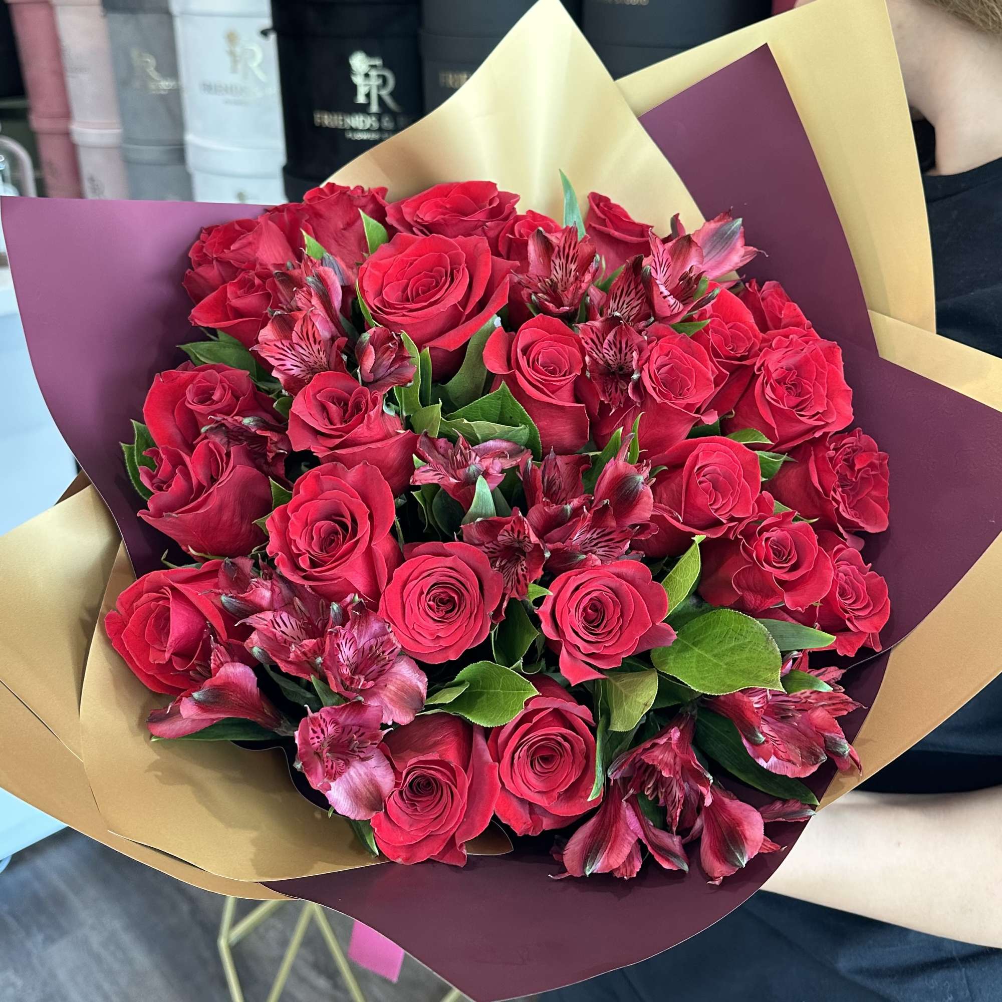 Bouquet of red roses and pink alstroemeria wrapped in burgundy and gold paper, photo 2 of 3