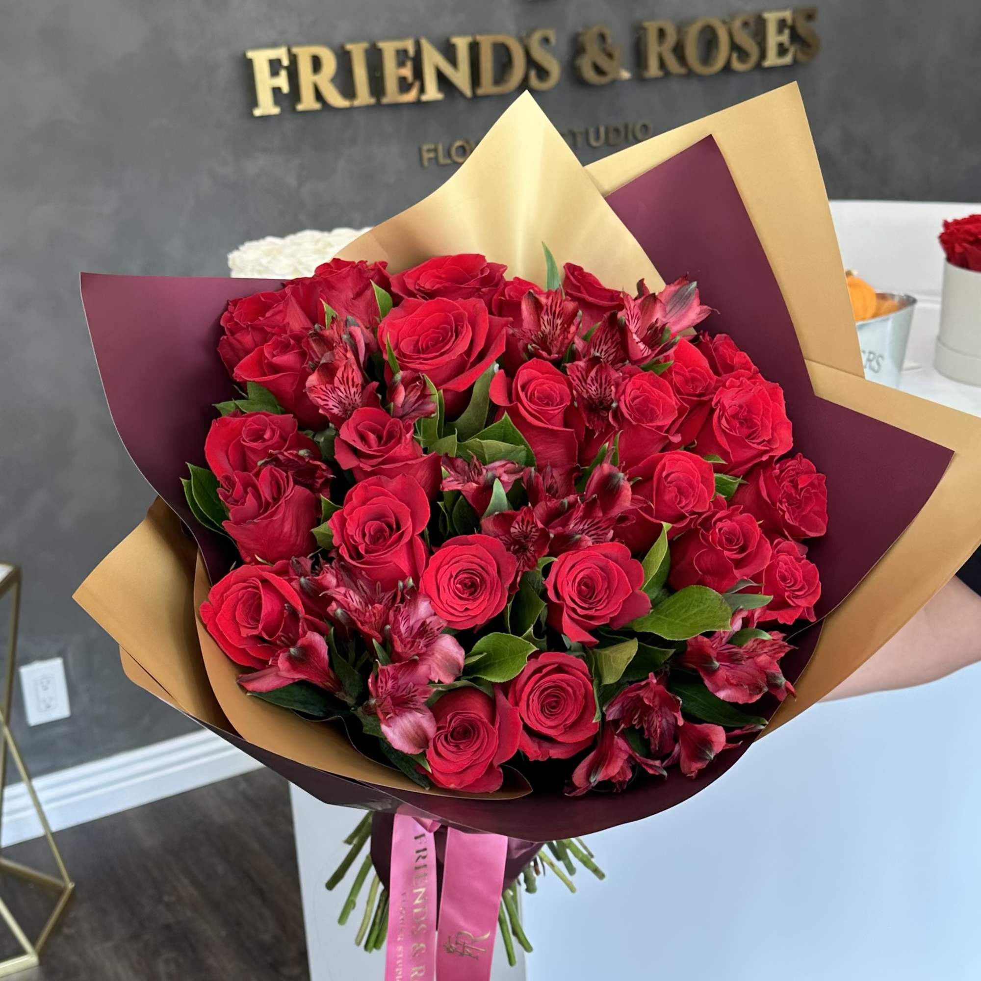Bouquet of red roses and pink alstroemeria wrapped in burgundy and gold paper, photo 3 of 3
