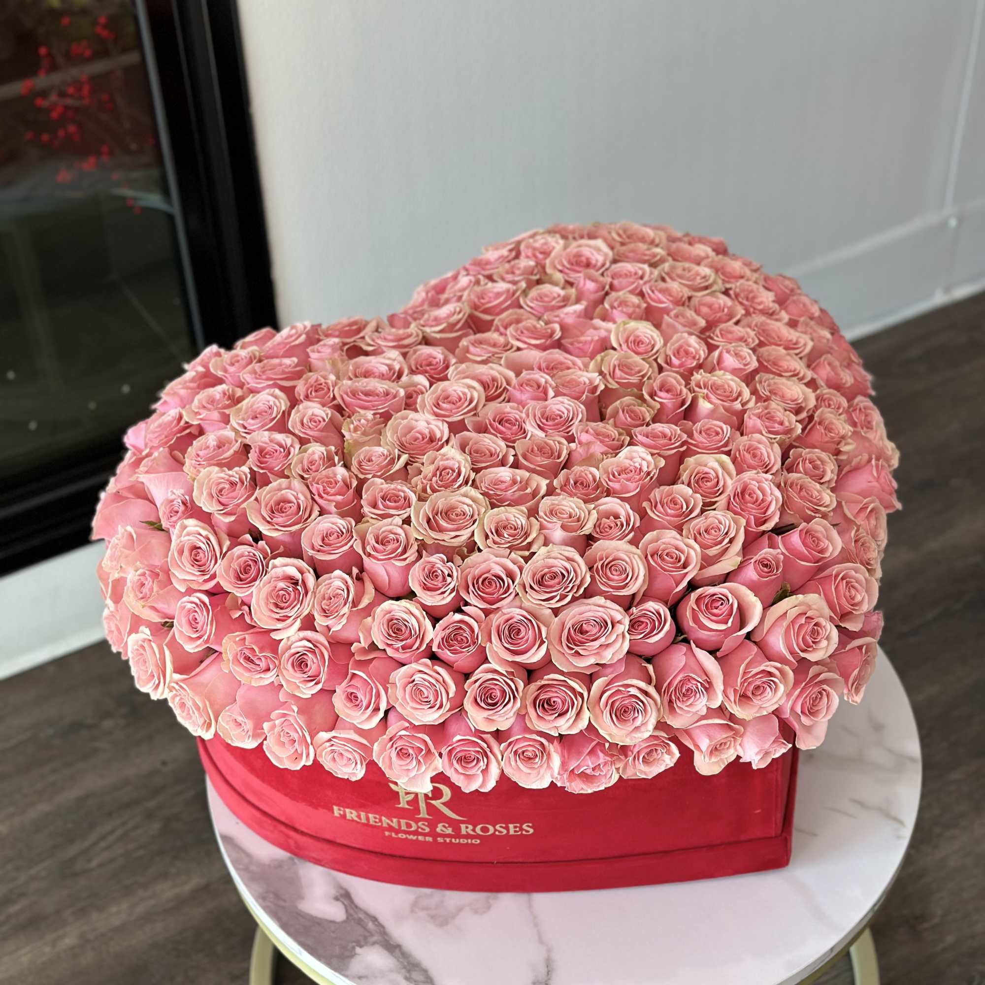 Large dome of pink roses in a red heart-shaped box