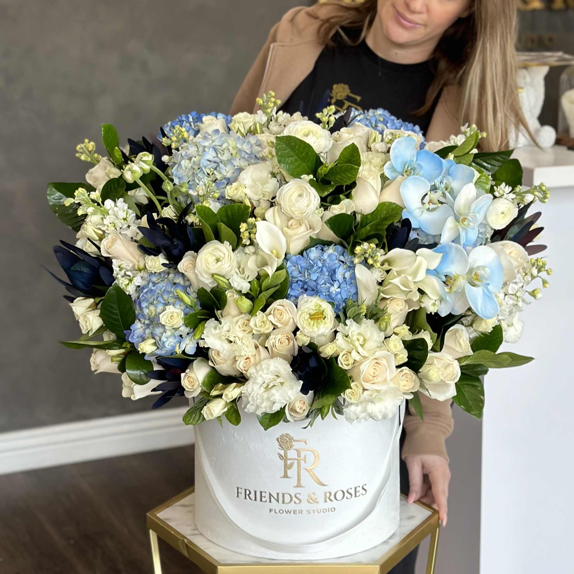 Large white hatbox arrangement of blue and white flowers