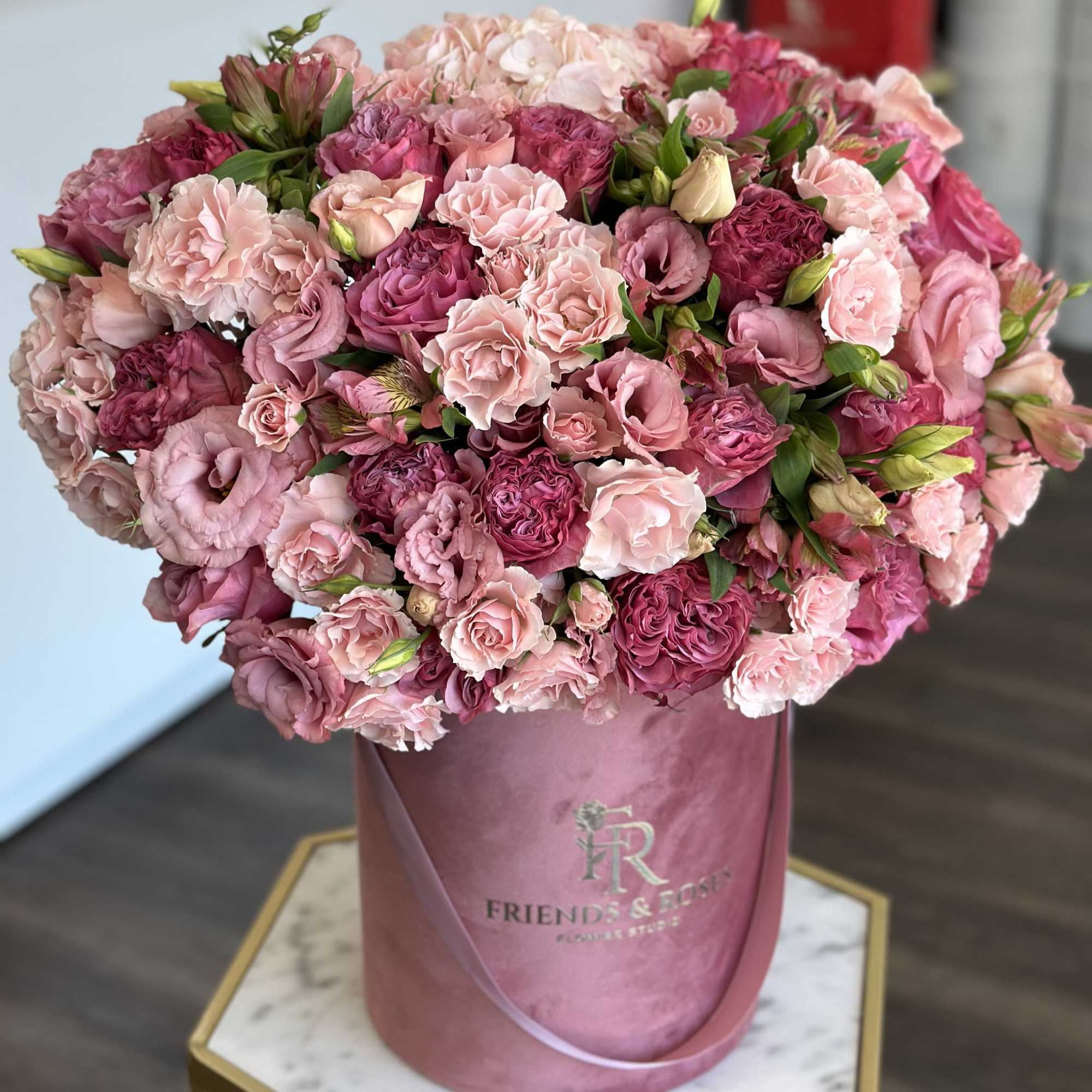 Pink and blush bouquet in a round pink box