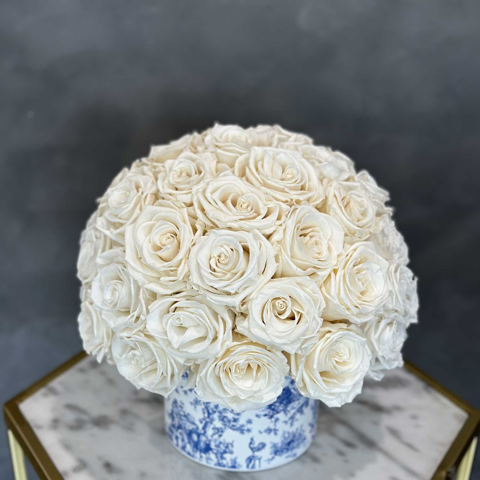 White rose bouquet in a blue-and-white ceramic vase