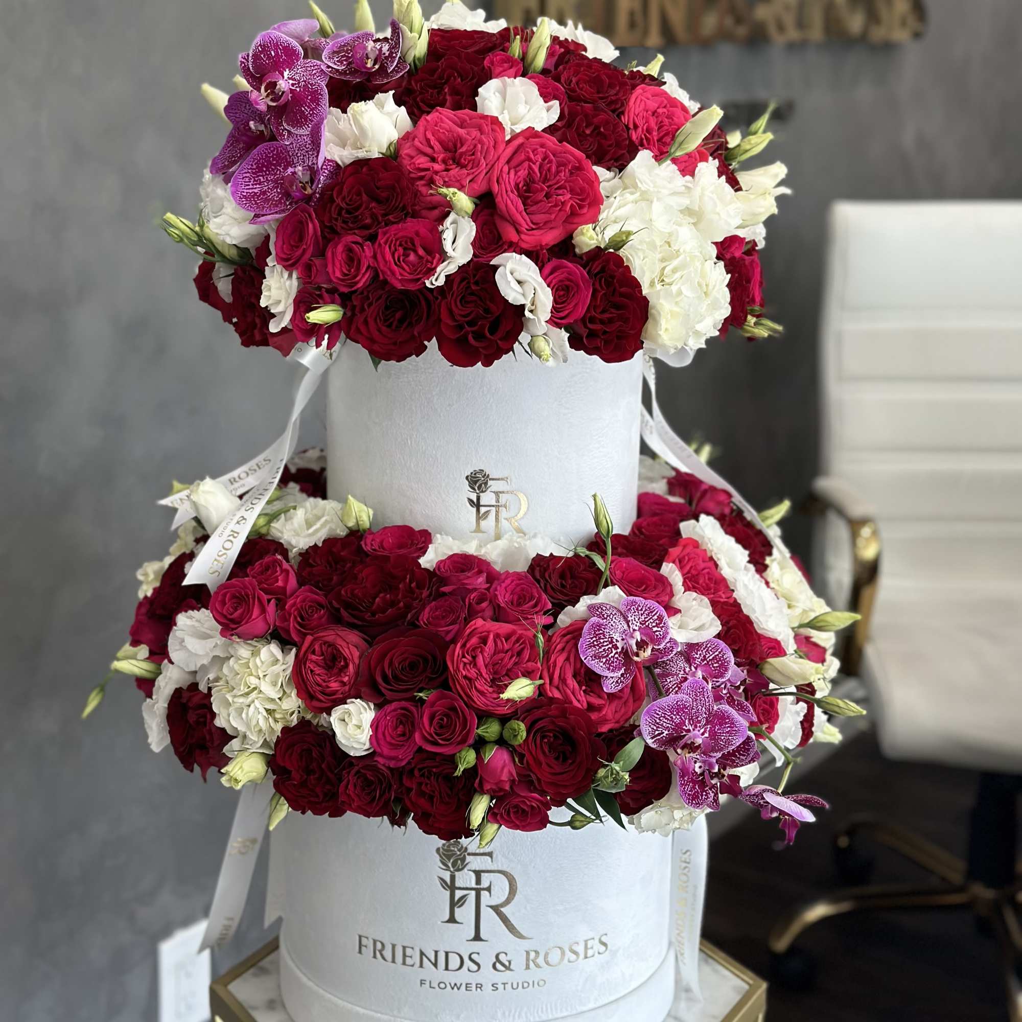 Two-tier flower box with red, pink, white, and purple blooms
