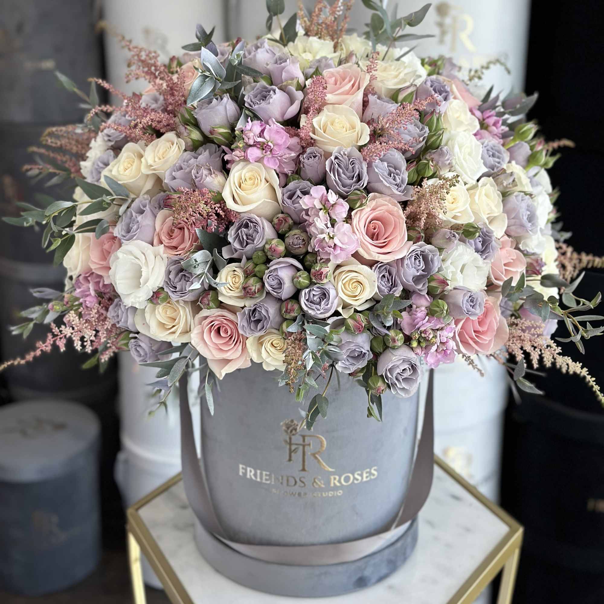 Large pastel rose arrangement in a gray hatbox, photo 2 of 3