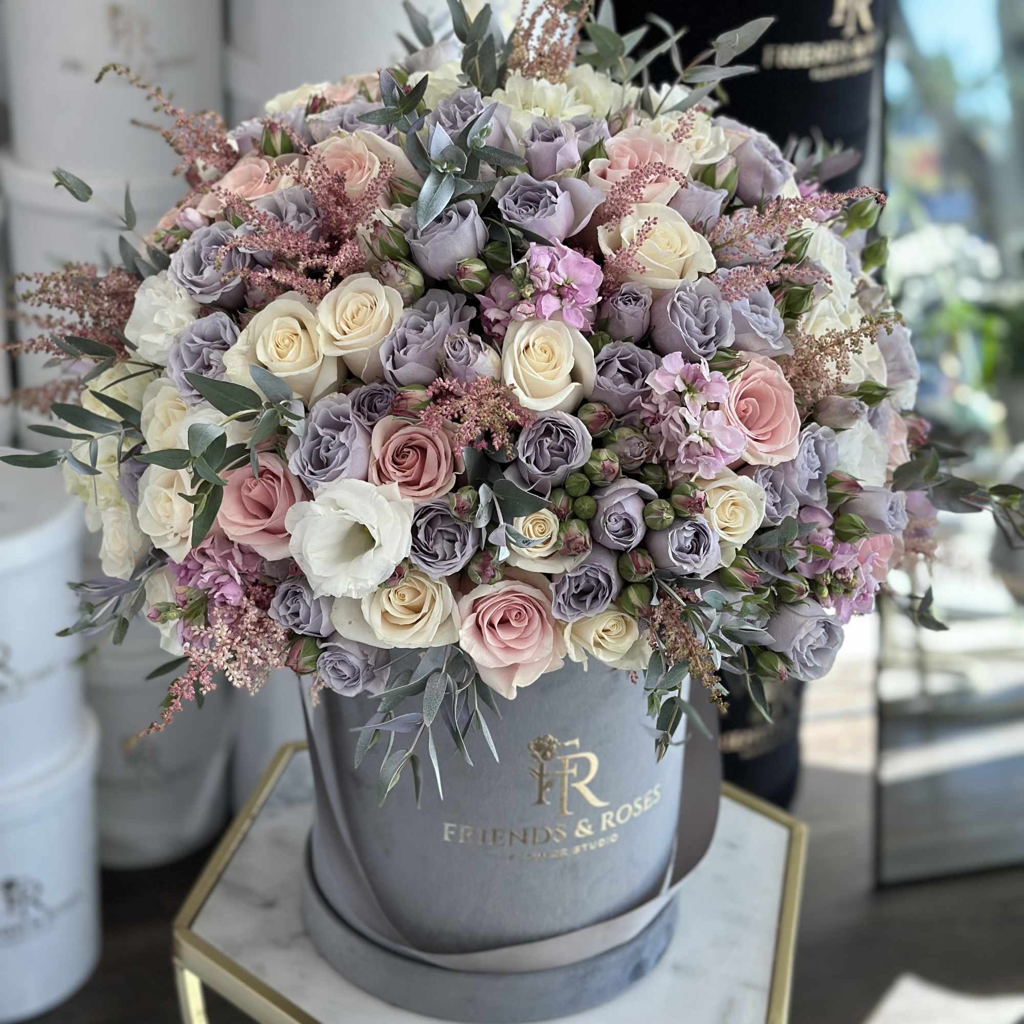 Large pastel rose arrangement in a gray hatbox, photo 3 of 3