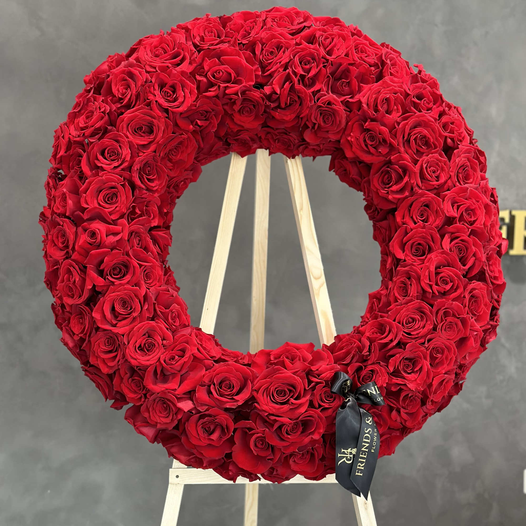 Large red rose wreath on a wooden easel