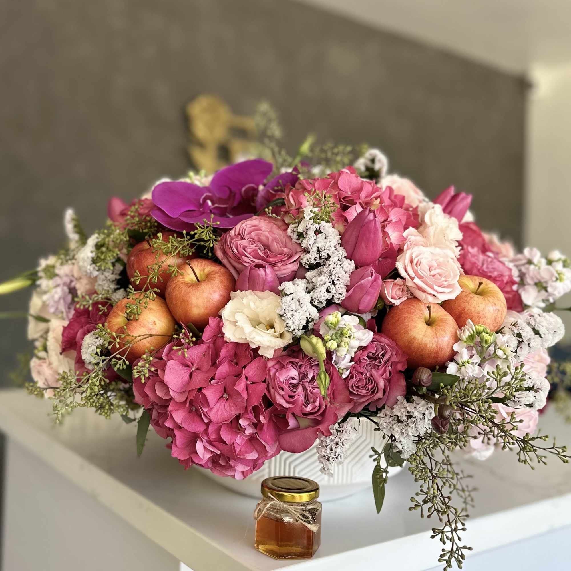 Pink floral arrangement with apples in a white vase, photo 2 of 3