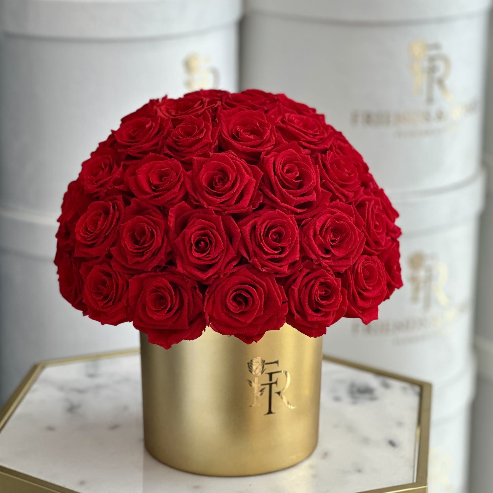 Red roses arranged in a gold cylindrical box, photo 2 of 3